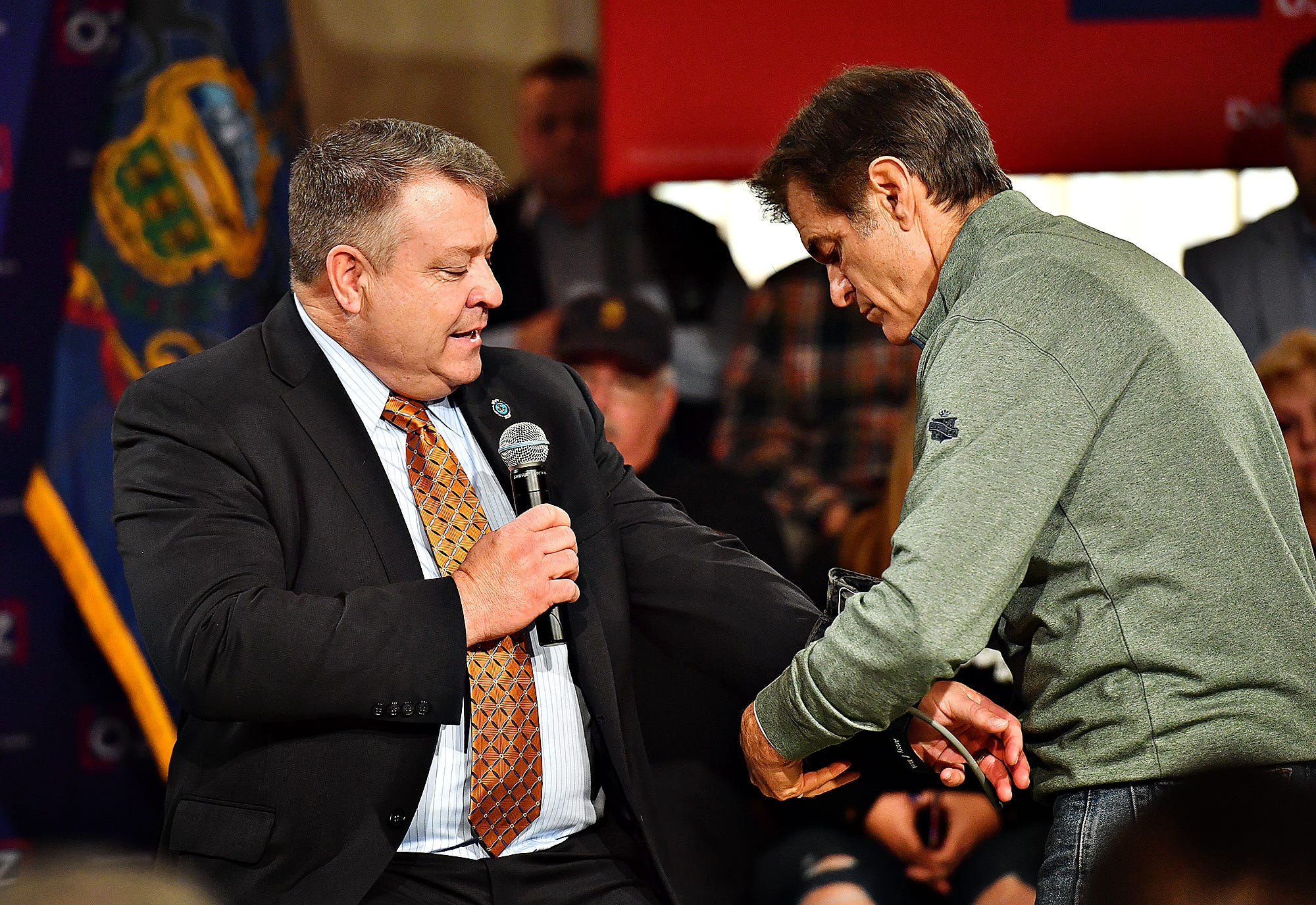 Dr. Mehmet Oz, right, takes a blood pressure reading for York County Regional Police Lt. Tobin Zech as they discuss law enforcement, during the fourth stop along the Doctor Oz for Senate campaign trail, at Wisehaven Event Center in Windsor Township, Saturday, Feb. 5, 2022. Dawn J. Sagert photo