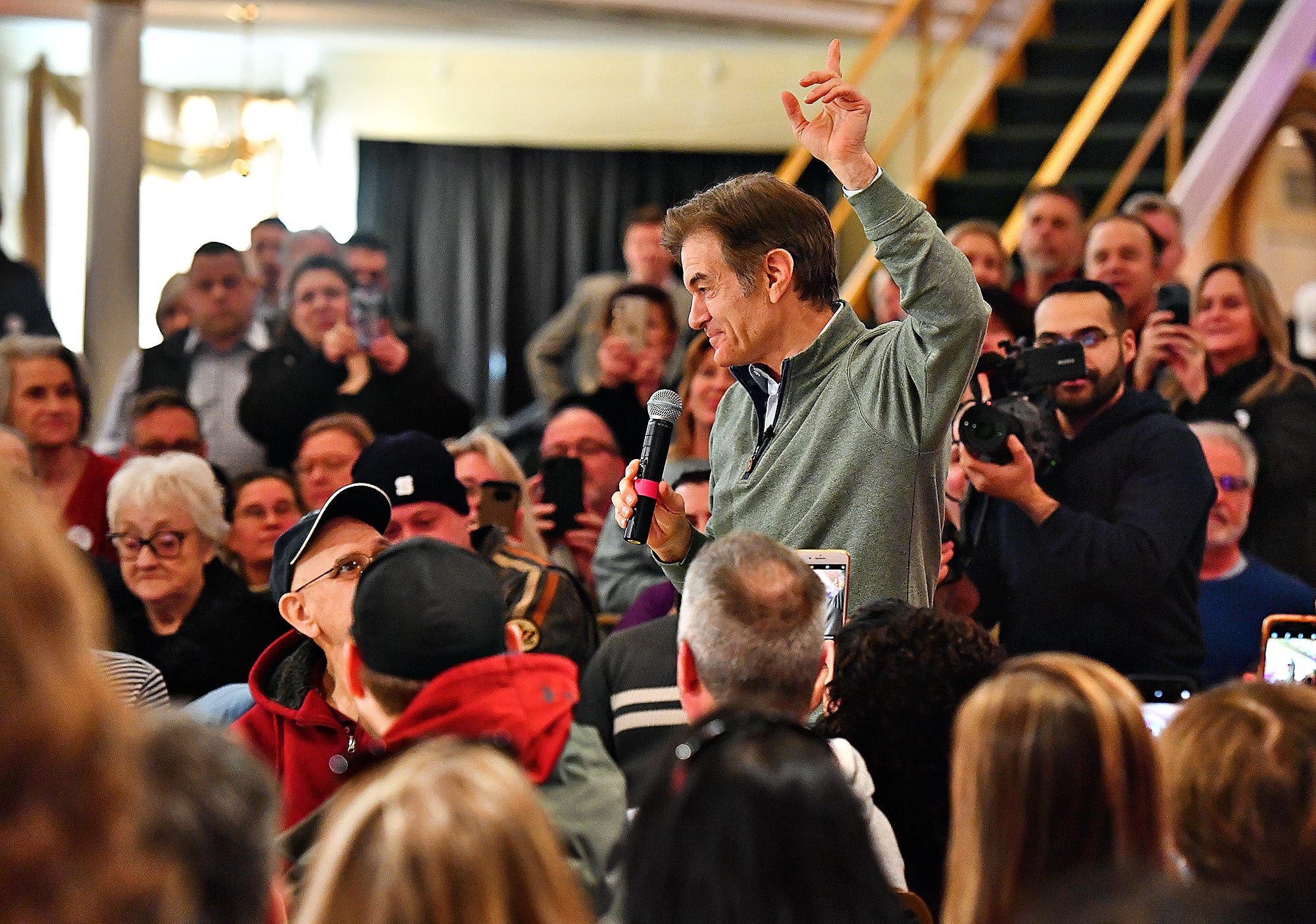 Supporteres look on as Dr. Mehmet Oz makes his entrance during the Doctor Oz for Senate campaign tour stop at Wisehaven Event Center in Windsor Township, Saturday, Feb. 5, 2022. Event organizers estimate about 350 were in attendance. Dawn J. Sagert photo