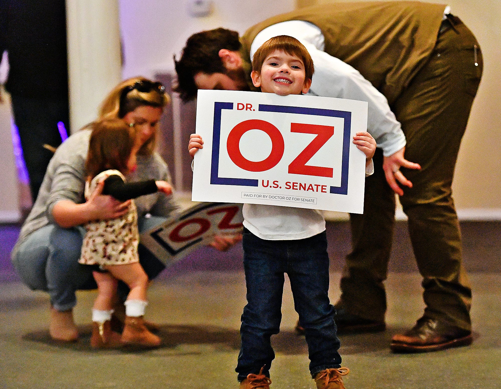 Bryce Baker, 4, of Cumberland County, poses with a campaign sign with his family in the background following the fourth stop along the Doctor Oz for Senate campaign trail at Wisehaven Event Center in Windsor Township, Saturday, Feb. 5, 2022. Baker's mother works for the campaign. Dawn J. Sagert photo