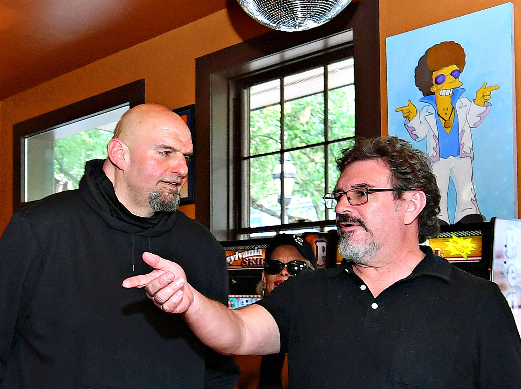 U.S. Senate candidate Lt. Gov. John Fetterman, left, talks to owner Scott Eden, of Holy Hound Taproom in York City, during a campaign stop in York Thursday, May 12, 2022. Dawn J. Sagert photo