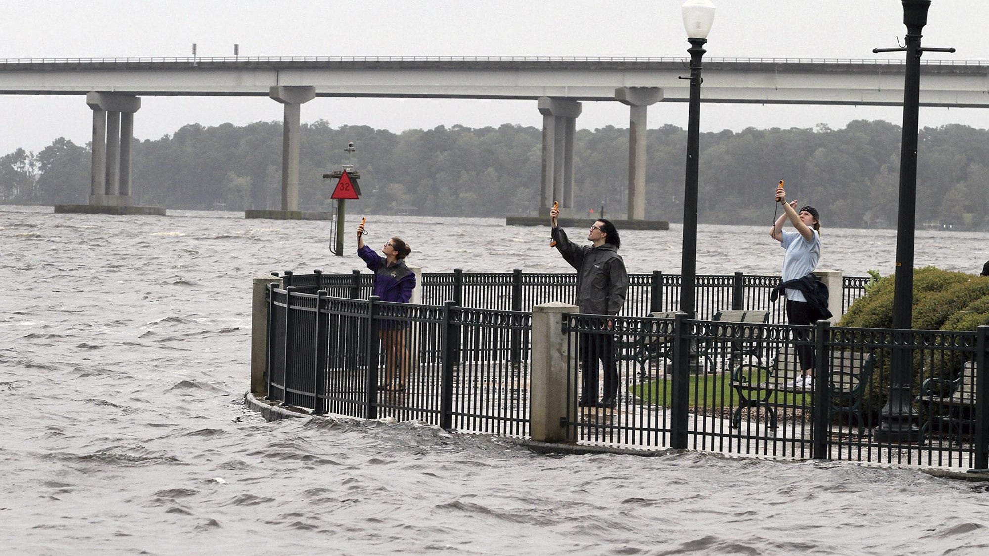 Students with Easty Carolina's Coastal Storms class use anemometers to measure wind speeds at Union Point Park in New Bern, N.C. Thursday, Sept. 13, 2018. Hurricane Florence already has inundated coastal streets with ocean water and left tens of thousands without power, and more is to come. (Gray Whitley/Sun Journal via AP)