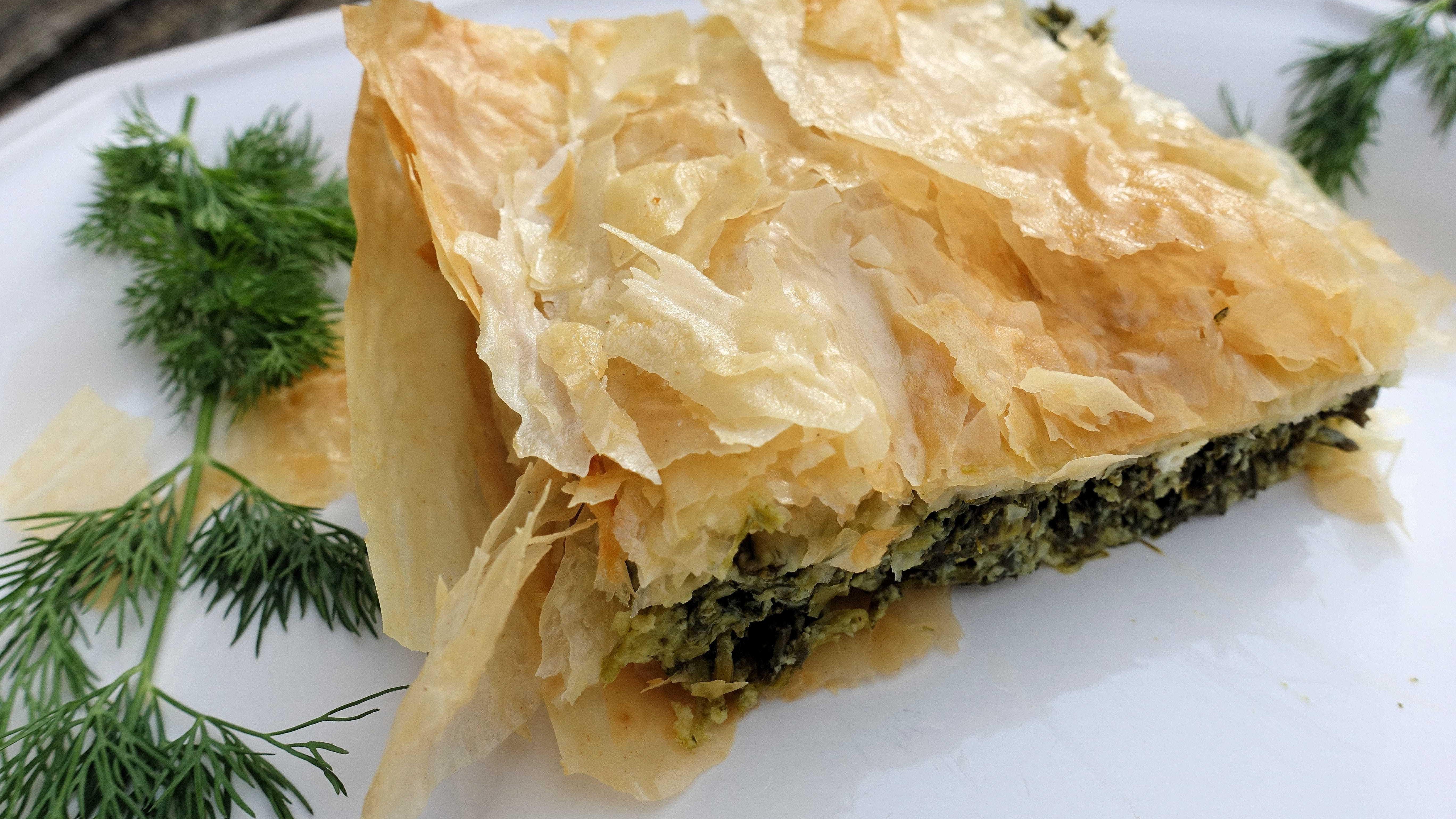Spanakopita, or Greek spinach pie, is a savory dish made with herbs, feta and delicate phyllo dough.