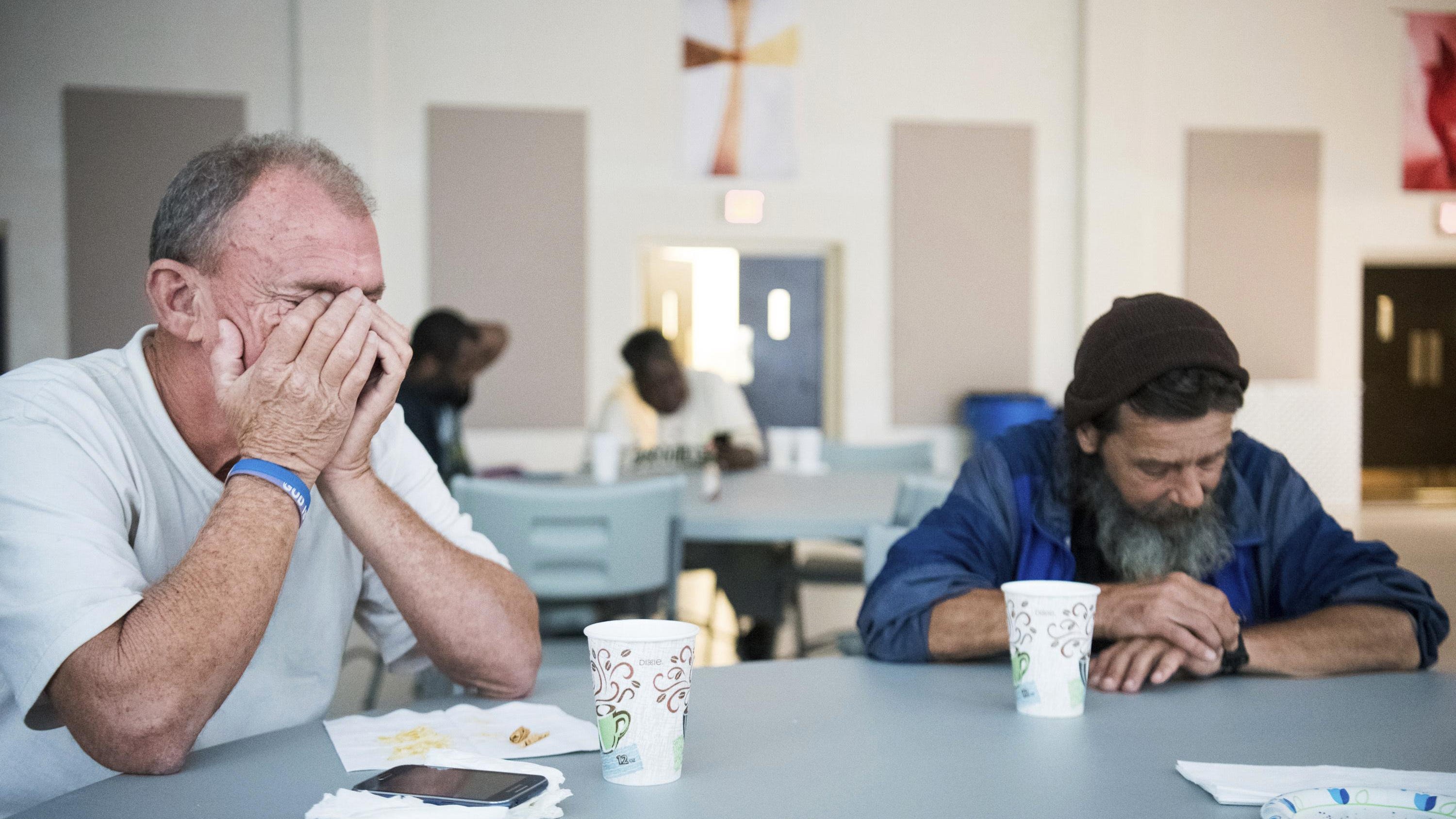 Stephen Mims, left, and David Lloyd wait for the storm to pass in a shelter at Washington Street United Methodist Church as remnants of Florence slowly move across the East Coast Saturday, Sept. 15, 2018, in Columbia, S.C. With rivers rising toward record levels, thousands of people were ordered to evacuate for fear the next few days could bring the most destructive round of flooding in North Carolina history. (AP Photo/Sean Rayford)