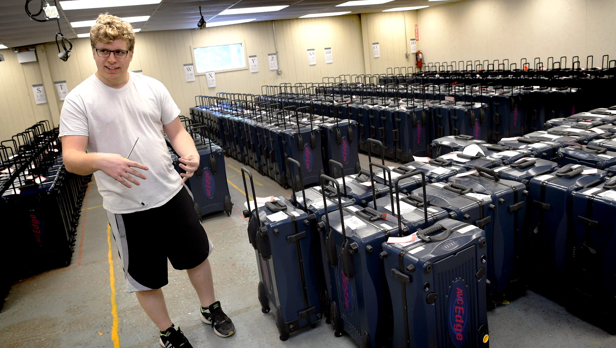 York County Voting Technology Coordinator Casey Brady talks about the 45 voting machines in disrepair in county elections at a storage warehouse in an undisclosed area Thursday, June 7, 2018. He repairs the machines and uses them for parts. He says the county has 624 working voting machines , background. He's been in the job for three months. "It's been a lot to pick up pretty quick," he said. In April, Gov. Tom Wolf directed all counties to replace machines, like those used in York County, with new voting machinesall offering paper trailsby 2020. Bill Kalina photo