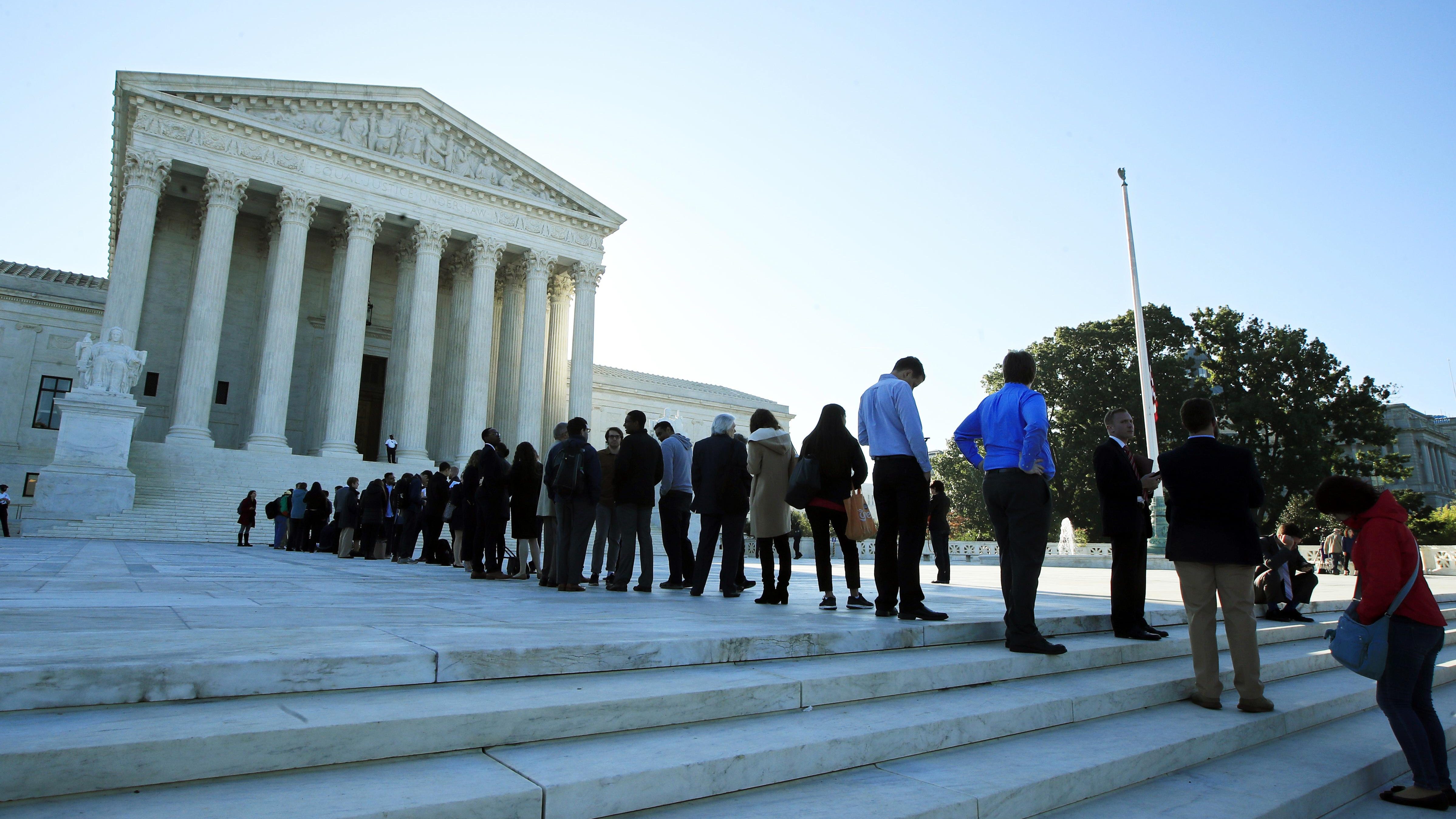 FILE - In this Oct. 3, 2017, file photo, people line up outside the U.S. Supreme Court in Washington to hear arguments in a case about political maps in Wisconsin that could affect elections across the country. The justices ruled against Wisconsin Democrats who challenged legislative districts that gave Republicans a huge edge in the state legislature. (AP Photo/Manuel Balce Ceneta, File)