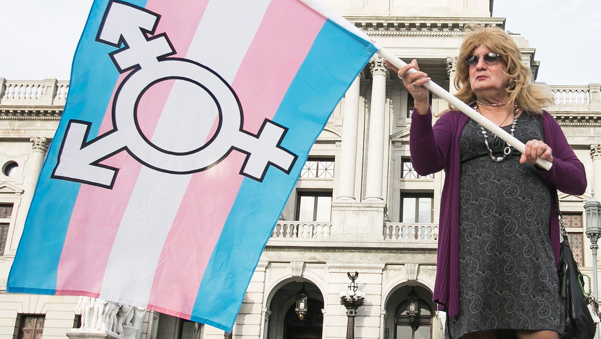 In this file photo, Ellen Davidson, of Elizabethtown, holds the transgender flag Thursday, March 31, 2016,  during a rally at the state Capitol to fight for the passage of the Fairness Act which would offer protections for LGBT individuals with regards to employment and housing. Amanda J. Cain photo