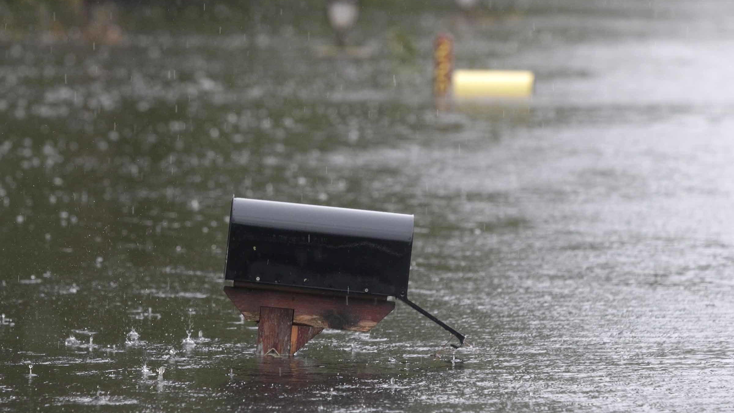 A flooded mailbox on Mill Creek Road is barely above water after Florence hit Newport N.C., Saturday, Sept. 15, 2018. A day after blowing ashore with 90 mph (145 kph) winds, Florence practically parked itself over land all day long and poured on the rain. (AP Photo/Tom Copeland)