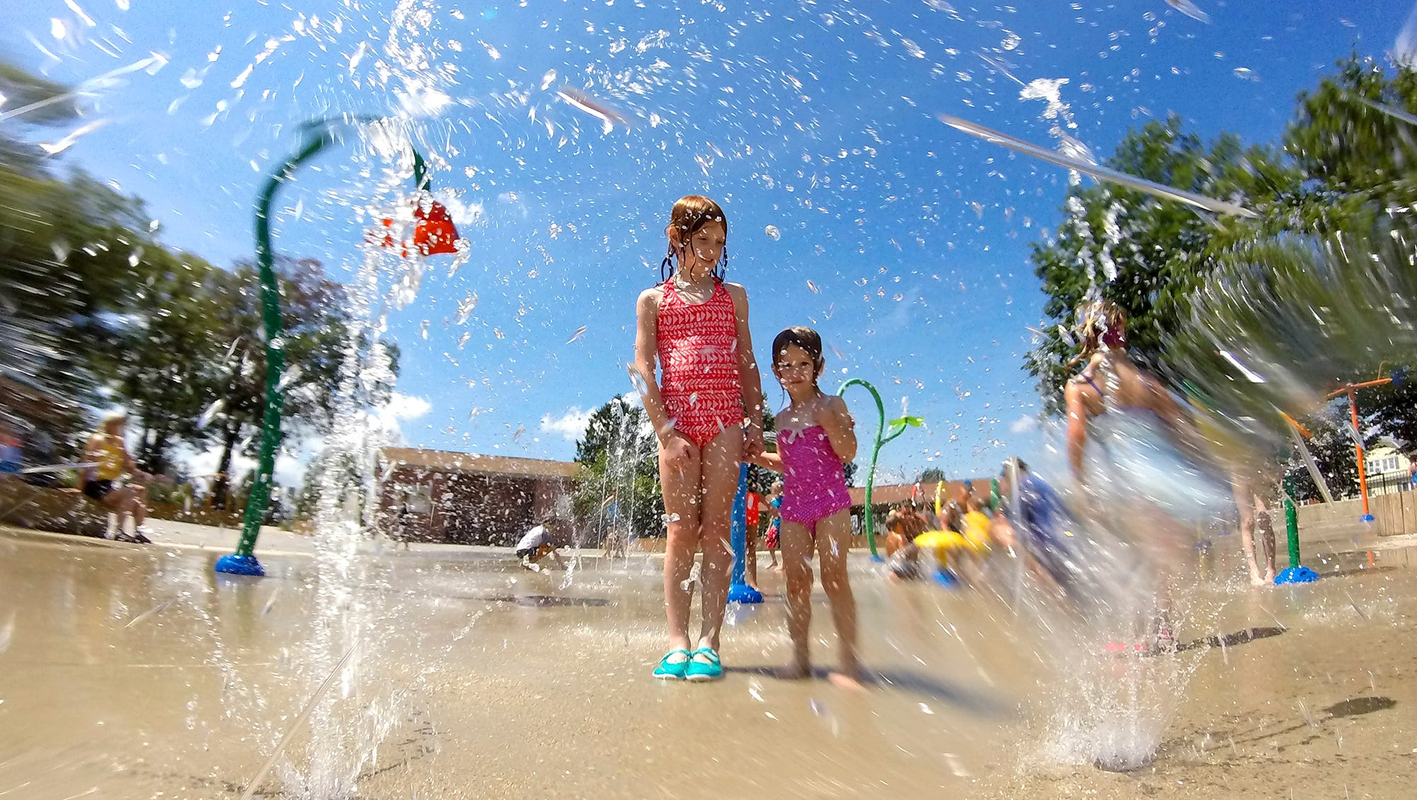 Clare Seifert, 8, left, and her sister Elise, 2, of Emigsville, stand in a spray of water at the Splash Pad in Red Lion, Friday, Aug. 12, 2016. John A. Pavoncello photo
