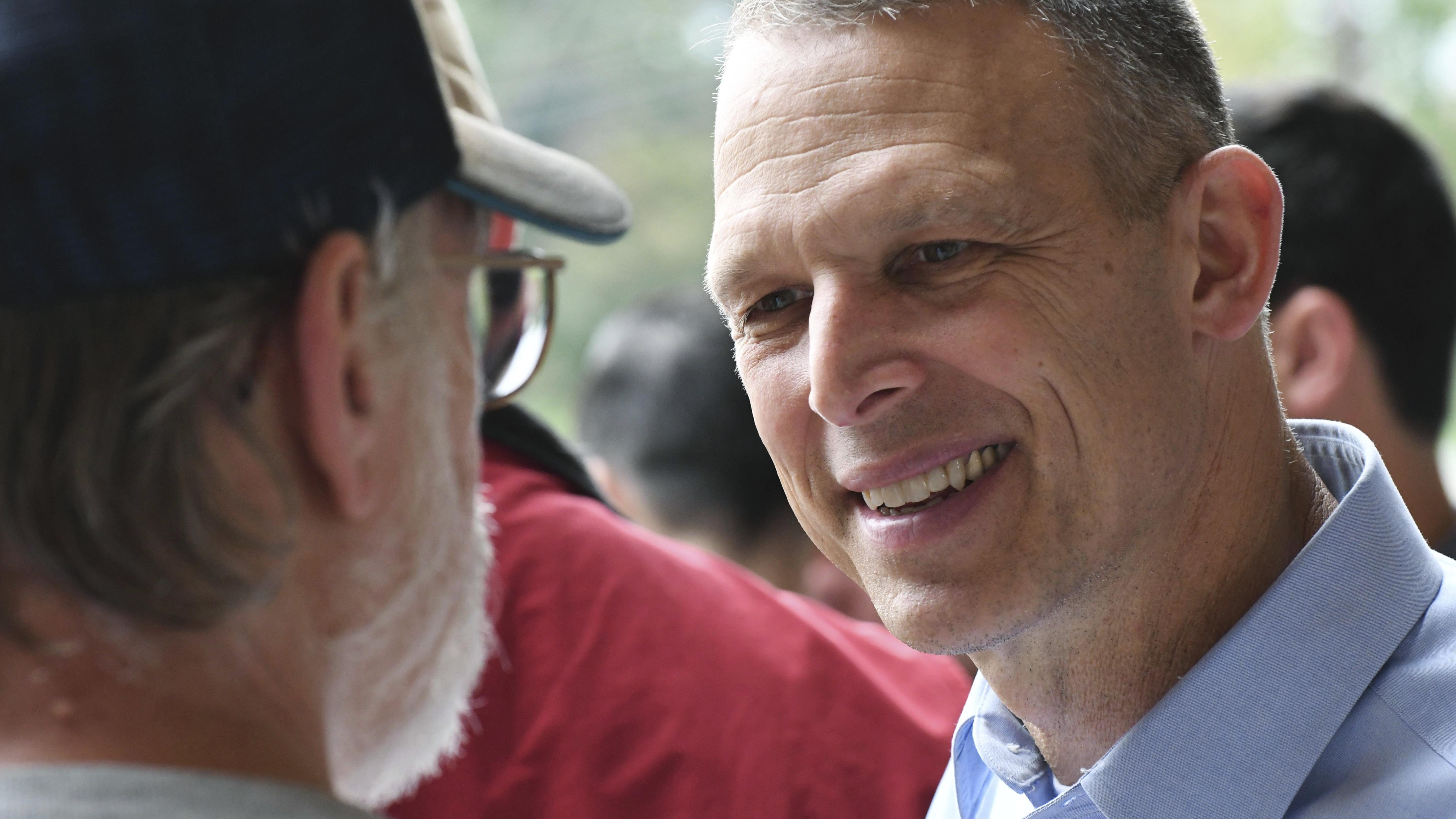 In this Oct. 6, 2018 photo, Republican U.S. Rep. Scott Perry of Pennsylvania speaks to a party committeeman at a rally with volunteer canvassers, in Harrisburg, Pa. A court-ordered redrawing of Pennsylvania's House districts has forced several Republican congressmen, including Perry, into more competitive seats and helped establish Pennsylvania as a key state for Democrats aiming to recapture the House majority. (AP Photo/Marc Levy)