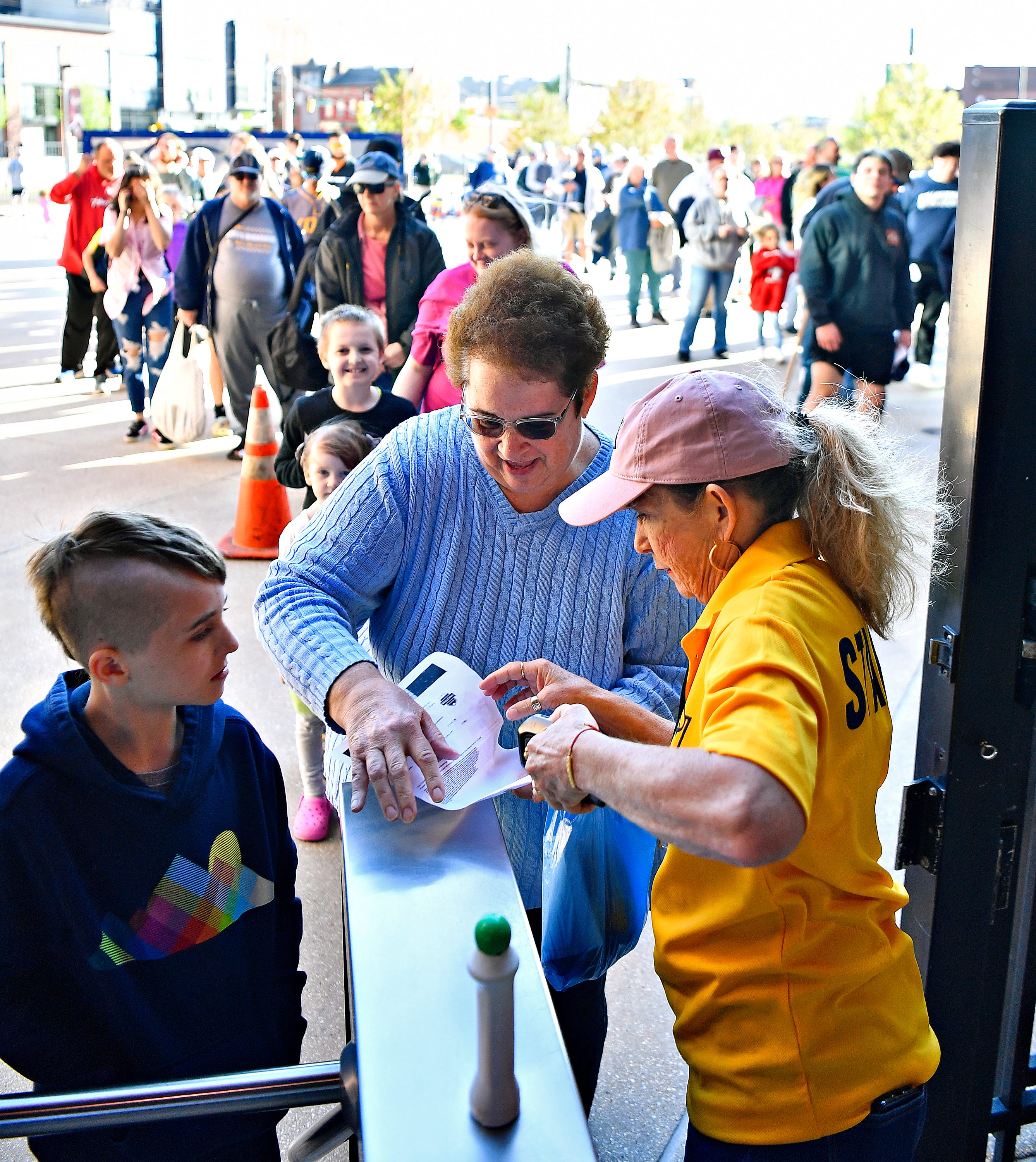 From right, Linda Hess, of York City, scans the tickets of Trena Stonebraker, of Manchester Township, and her grandson Cole Youngblood, 9, of Hallam Township, during York Revolution’s Fan Fest at WellSpan Park in York City, Saturday, April 20, 2024. (Dawn J. Sagert/The York Dispatch)
