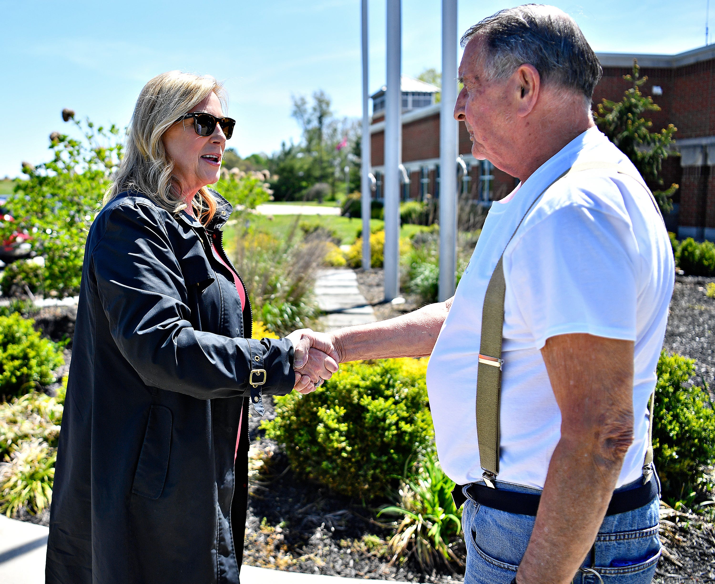 Janelle Stelson, Democratic candidate for the 10th Congressional District, greets voter Richard Helfrich, of Manchester Township, outside of the Manchester Township Building during Primary Election Day in Manchester Township, Tuesday, April 23, 2024. (Dawn J. Sagert/The York Dispatch)