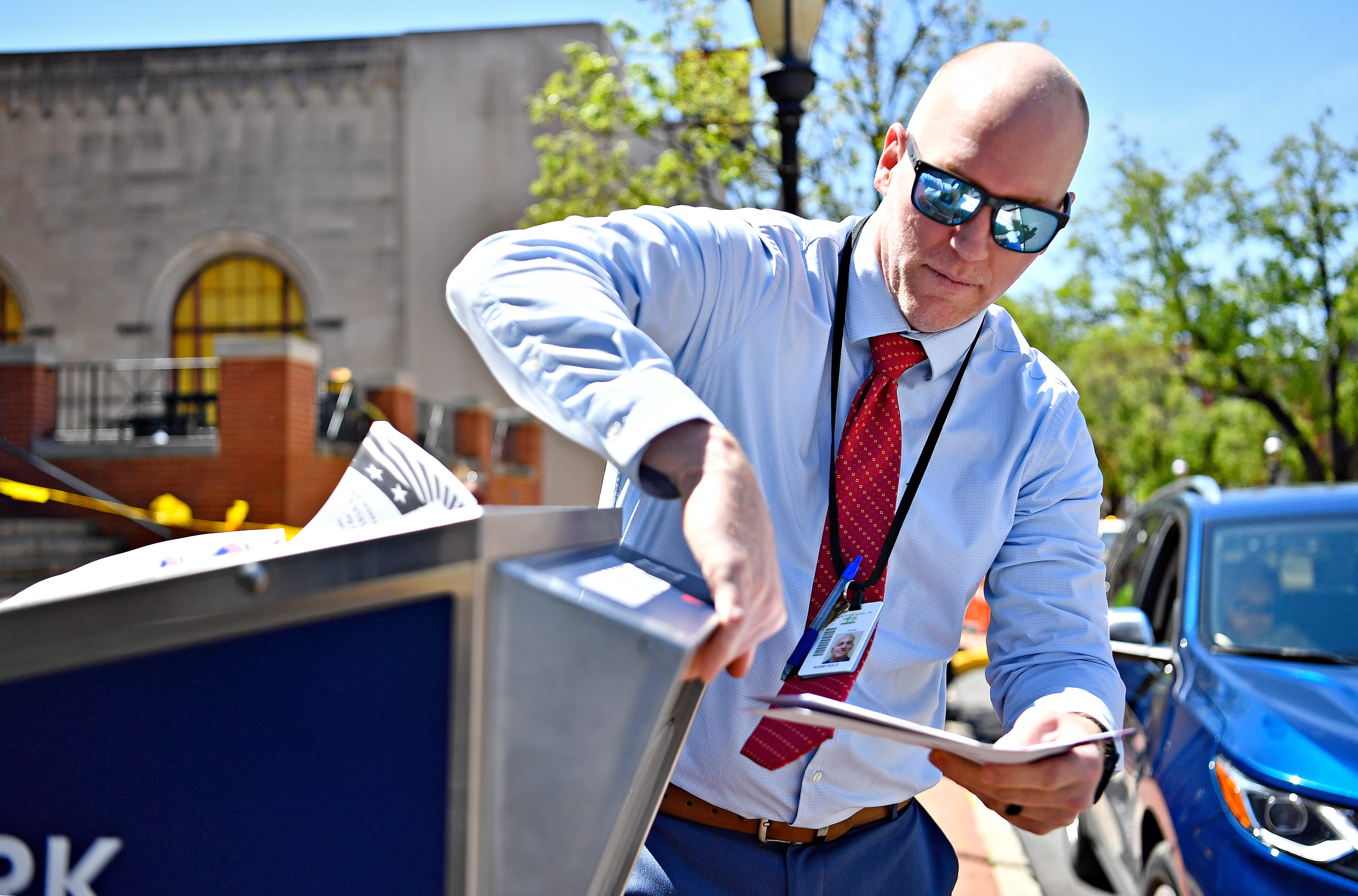 York County Prison Warden Adam Ogle slips ballots being dropped off into a secured drop box in front of the York County Administrative Center on East Market Street in York City during Primary Election Day, Tuesday, April 23, 2024. (Dawn J. Sagert/The York Dispatch)