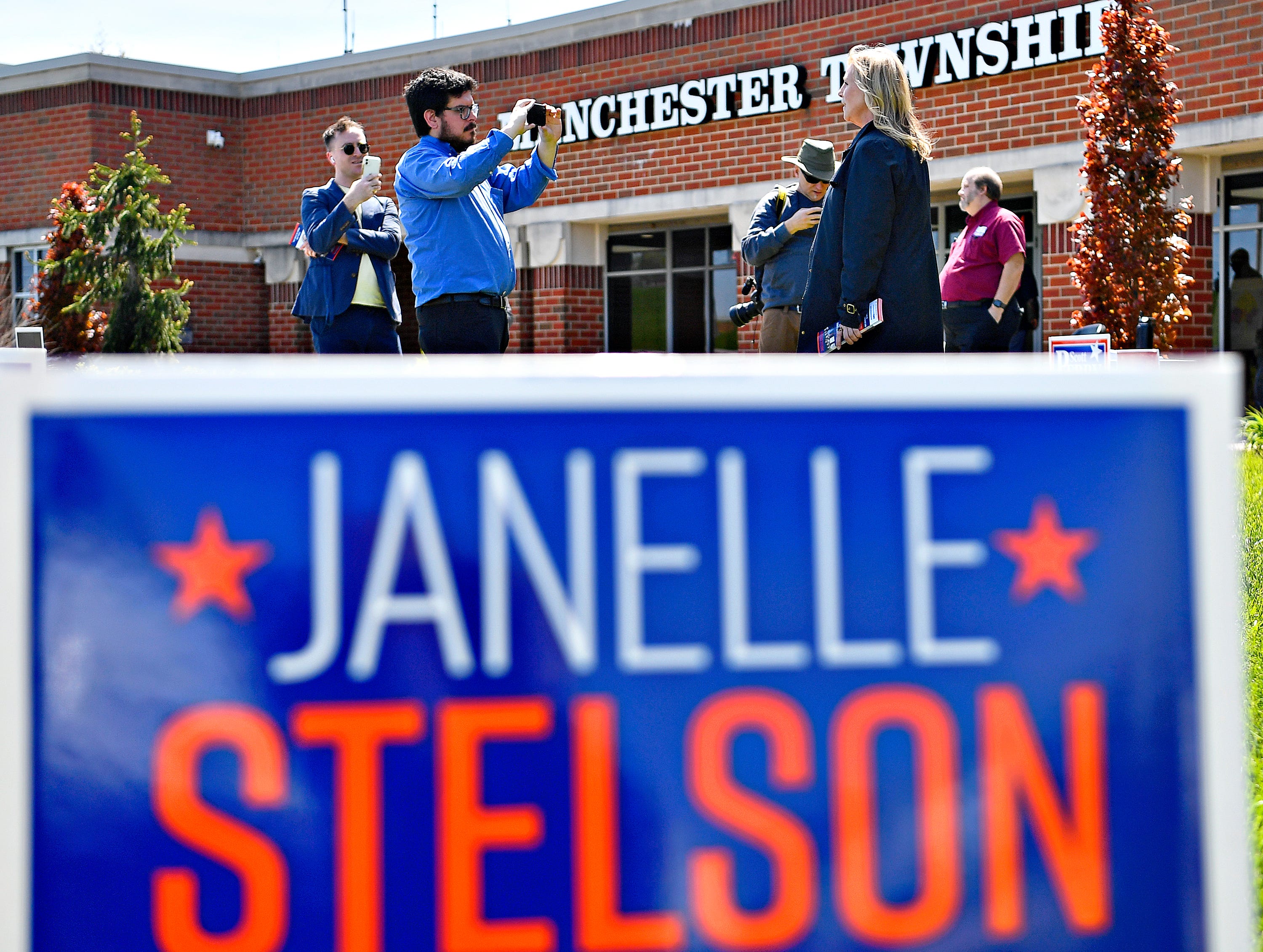 Janelle Stelson, Democratic candidate for the 10th Congressional District, front right, is interviewed by York Dispatch reporter Matthew Enright, outside of the Manchester Township Building during Primary Election Day in Manchester Township, Tuesday, April 23, 2024. (Dawn J. Sagert/The York Dispatch)