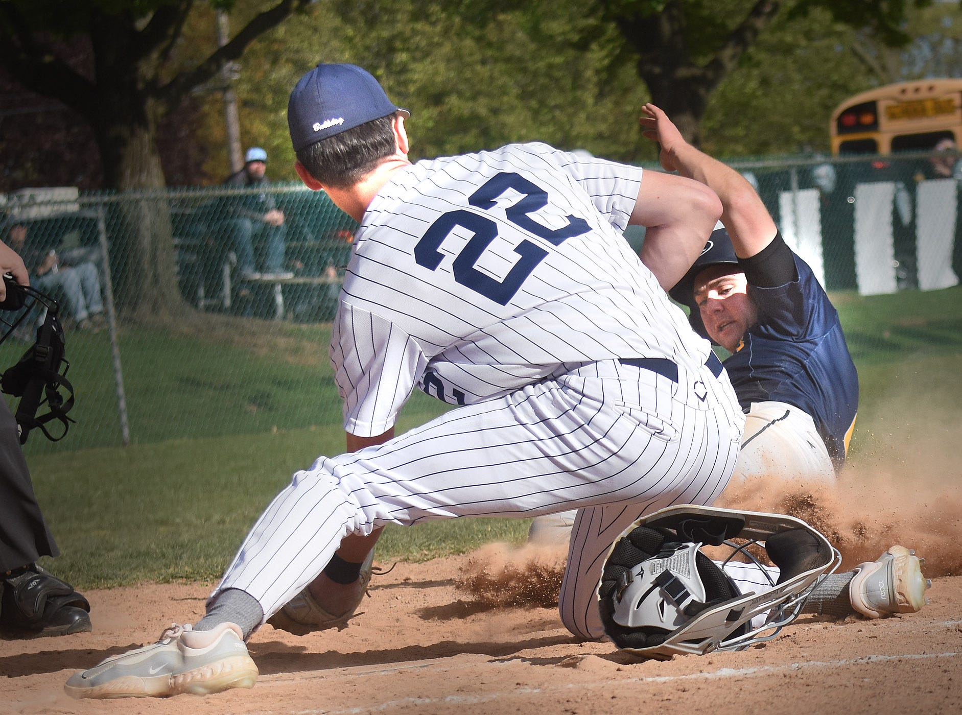 West York pitcher Collin Biehl (22) protects home plate as Littlestown's Lucas Bacher attempts to slide in during a York-Adams Division III baseball game Wednesday, April 24, 2024, at Sunset Lane Park in West Manchester Township. West York walked off with an 11-10 win in nine innings.