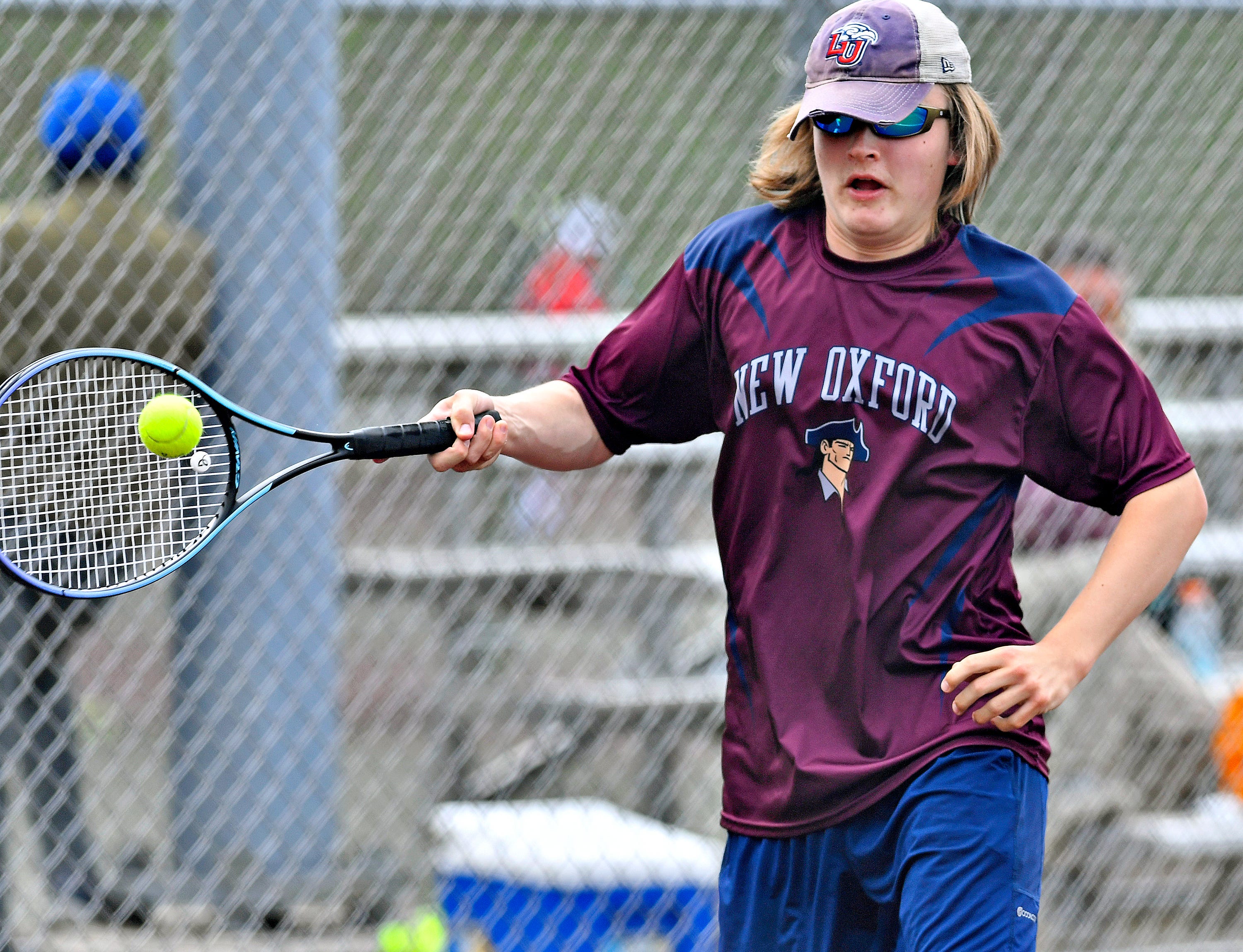 New Oxford’s Luke Malinowski during YAIAA boys’ 3A singles tennis tournament action at Red Lion Area Senior High School in Red Lion, Thursday, April 25, 2024. (Dawn J. Sagert/The York Dispatch)
