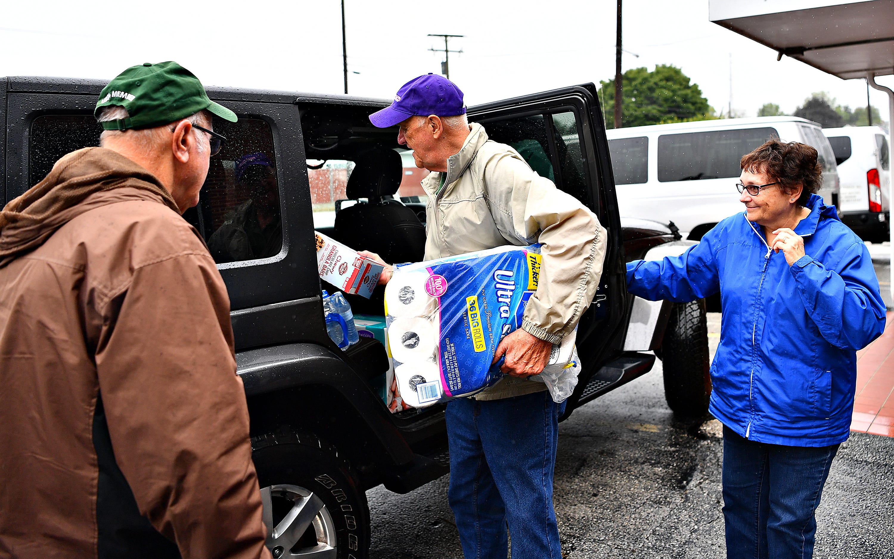 Fred Noble, center, of Bailey Coach, receives a donation from Dennis Delp, left, and Linda Delp, both of West Manchester Township, at Bailey Coach in West Manchester Township, Tuesday, Sept. 11, 2018. The items collected will be delivered to areas that are projected to be in the path of Hurricane Florence. Dawn J. Sagert photo
