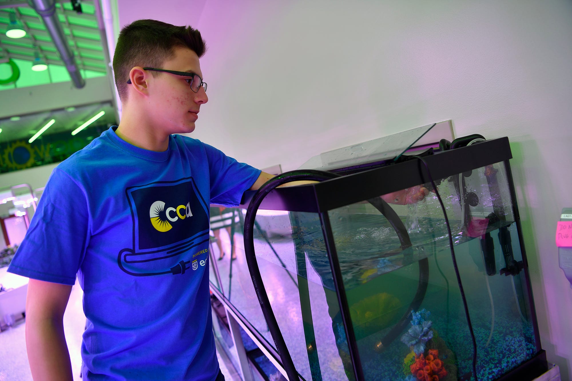 Nathaniel Saxe, a CCA junior from Springettsbury Township, fills fish tanks for tilapia fry at the Agworks aquaponics facility in Harrisburg, Tuesday, January 8, 2019.  
John A. Pavoncello photo