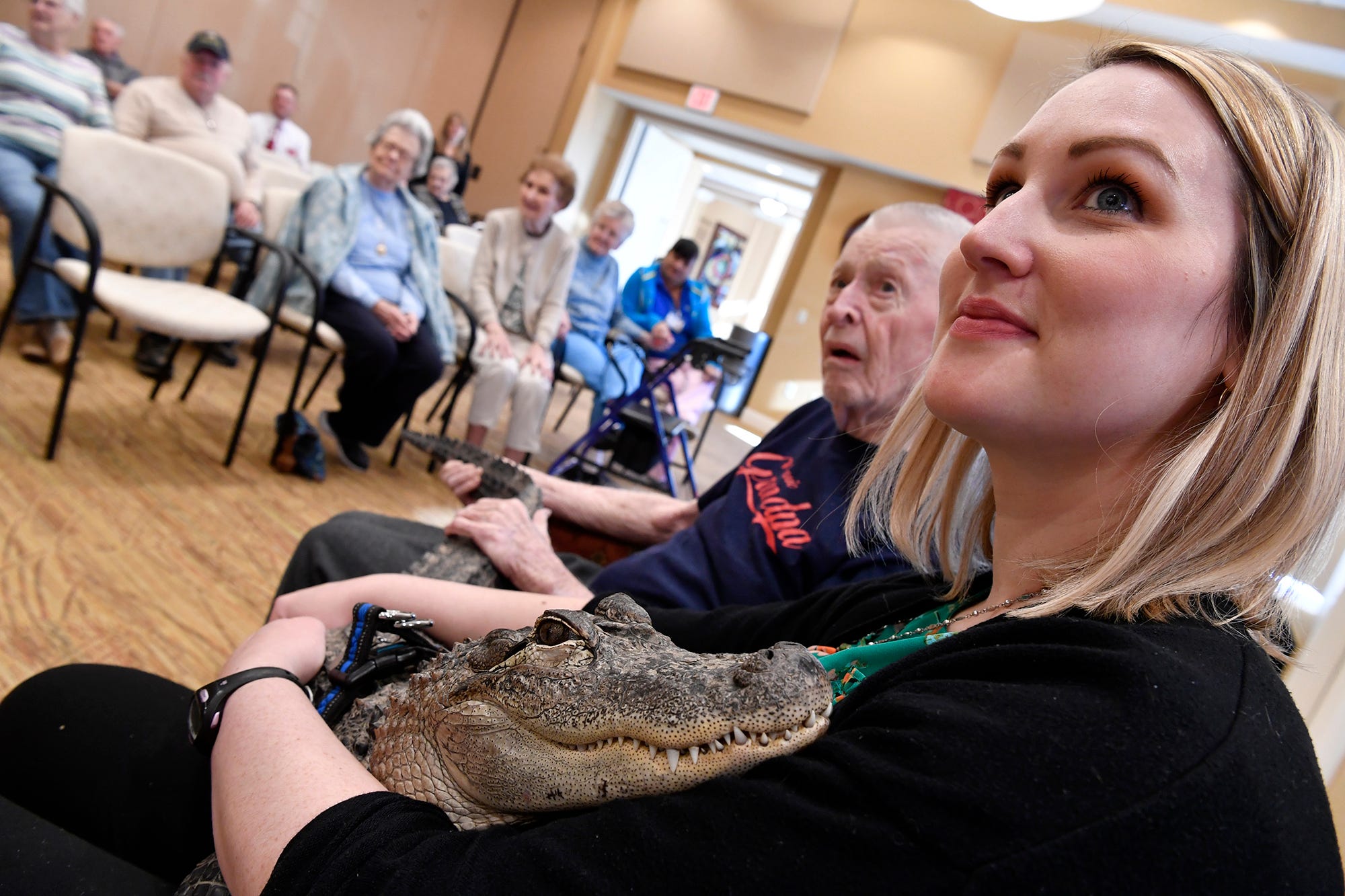 Holly Armstrong, Community Life Enrichment Director, right, and Ron Snyder, 88, cuddle with Wally the emotional support alligator, Monday, January 14, 2019.
John A. Pavoncello photo