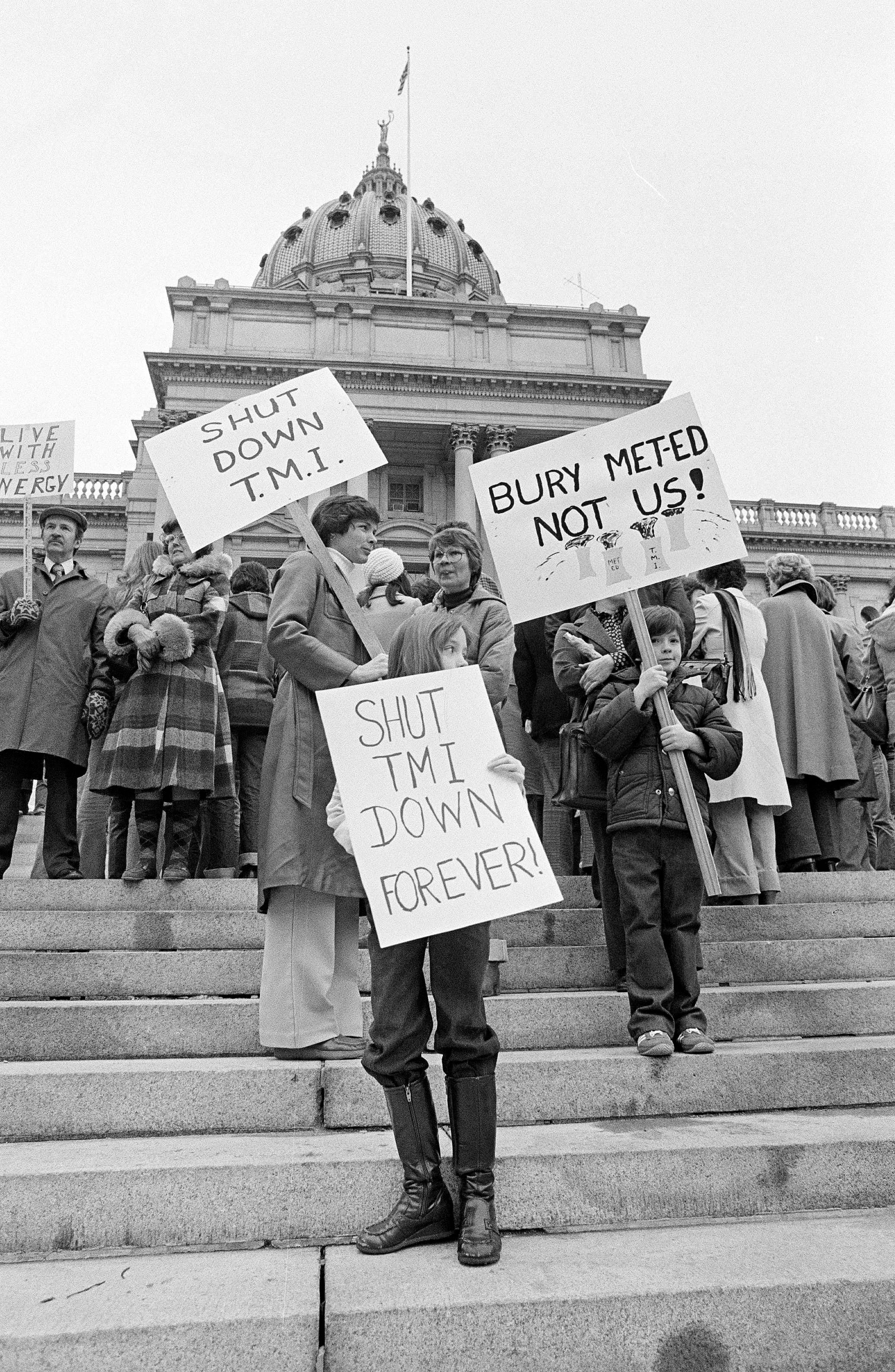 Two mothers along with their children carry signs in front of the State Capitol in Harrisburg, Penn., joining other anti-nuclear power plant demonstrators urging the shut-down of Three Mile Island (TMI) nuclear power plant near Harrisburg, April 8, 1979. The plant had an accident causing radiation to leak into the atmosphere. (AP Photo/Paul Vathis)