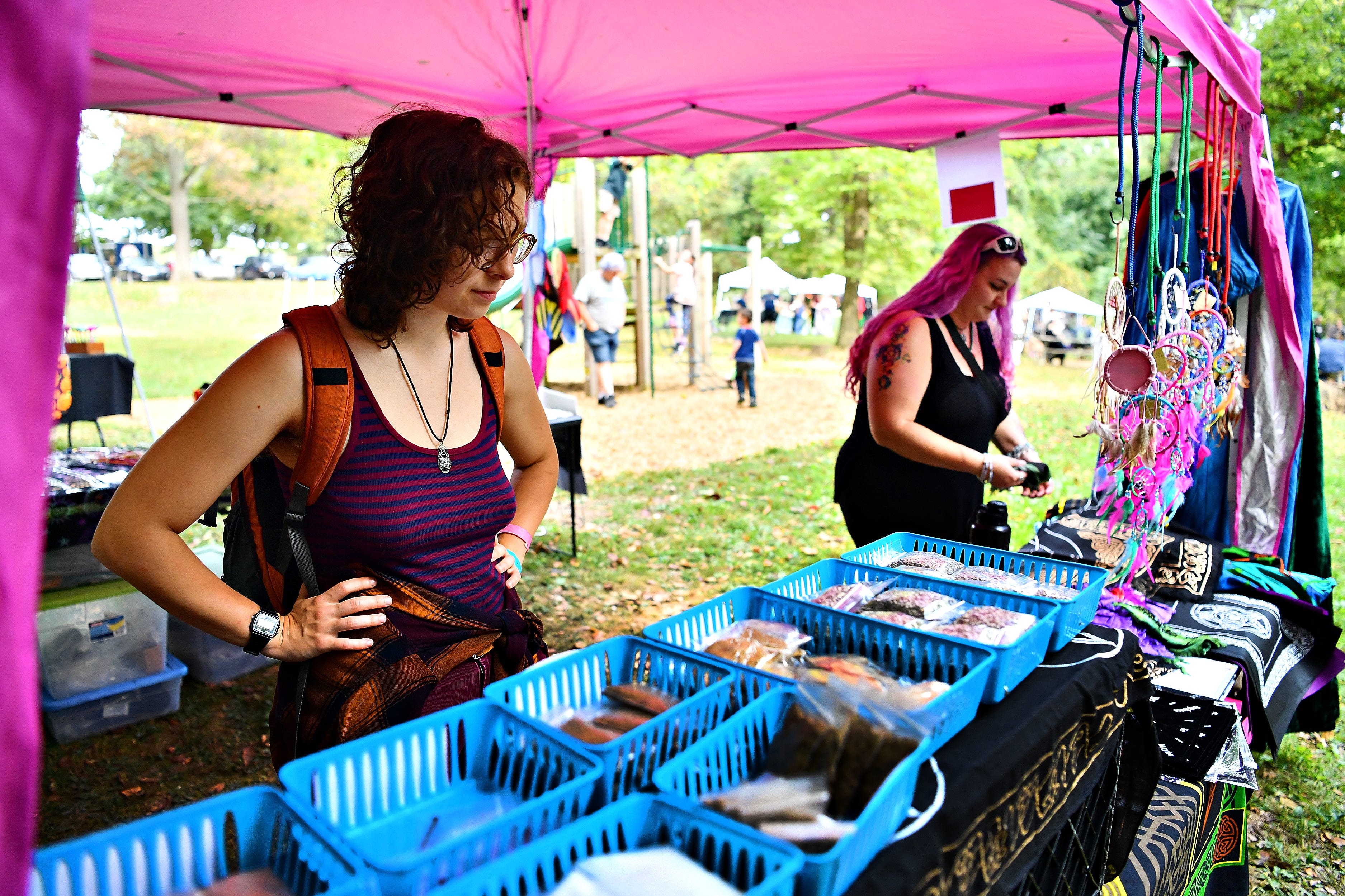 Melanie Gorguny, of Reading, left, and Marianne Hawkspirit, of Shermansdale in Perry County, shop at the Needful Things vendor tent during the 8th annual Pagan Pride Festival at Samuel S. Lewis State Park in Lower Windsor Township, Saturday, Sept. 28, 2019. Dawn J. Sagert photo