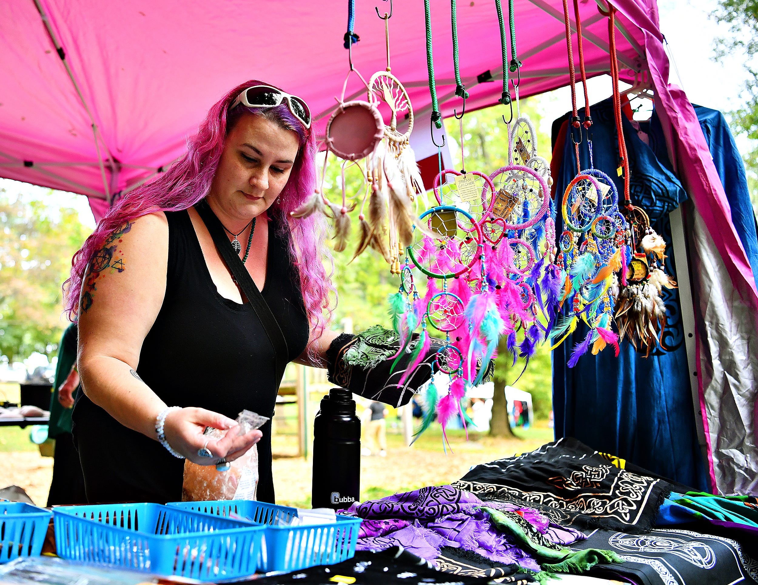 Marianne Hawkspirit, of Shermansdale in Perry County, shops at the Needful Things vendor tent during the 8th annual Pagan Pride Festival at Samuel S. Lewis State Park in Lower Windsor Township, Saturday, Sept. 28, 2019. Dawn J. Sagert photo