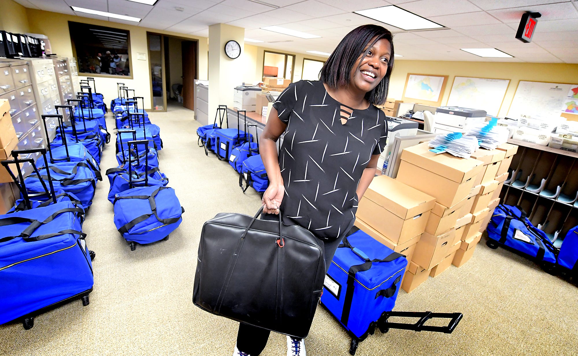 York County Elections and Voter Registration Director Nikki Suchanic holds a bag of ballots while standing amid cases loaded with them in the Elections Office at the York County Administrative Center Wednesday, November 6, 2019. Problems with the new voting procedures on Election Day required the ballots to be rescanned. Bill Kalina photo