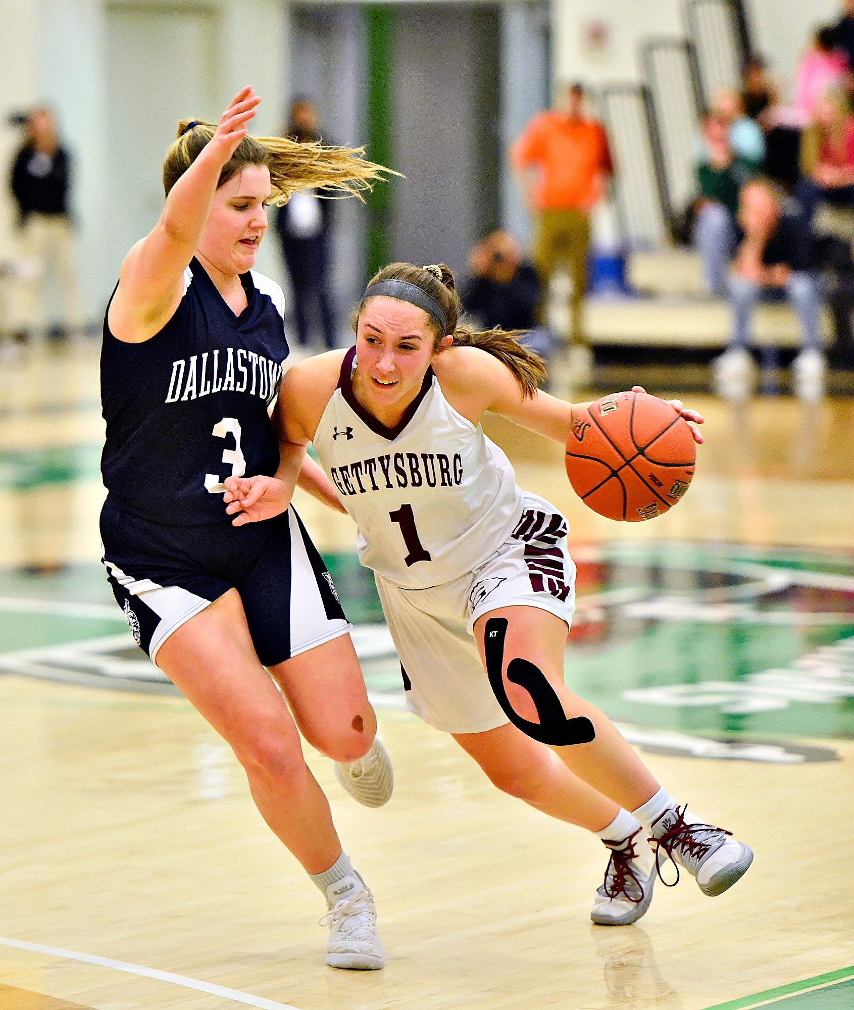 Gettysburg's Camryn Felix, right, works to get around Dallastown's Claire Teyral during YAIAA girls' basketball championship action at Grumbacher Sport and Fitness Center at York College of Pennsylvania in Spring Garden Township, Friday, Feb. 14, 2020. Dawn J. Sagert photo