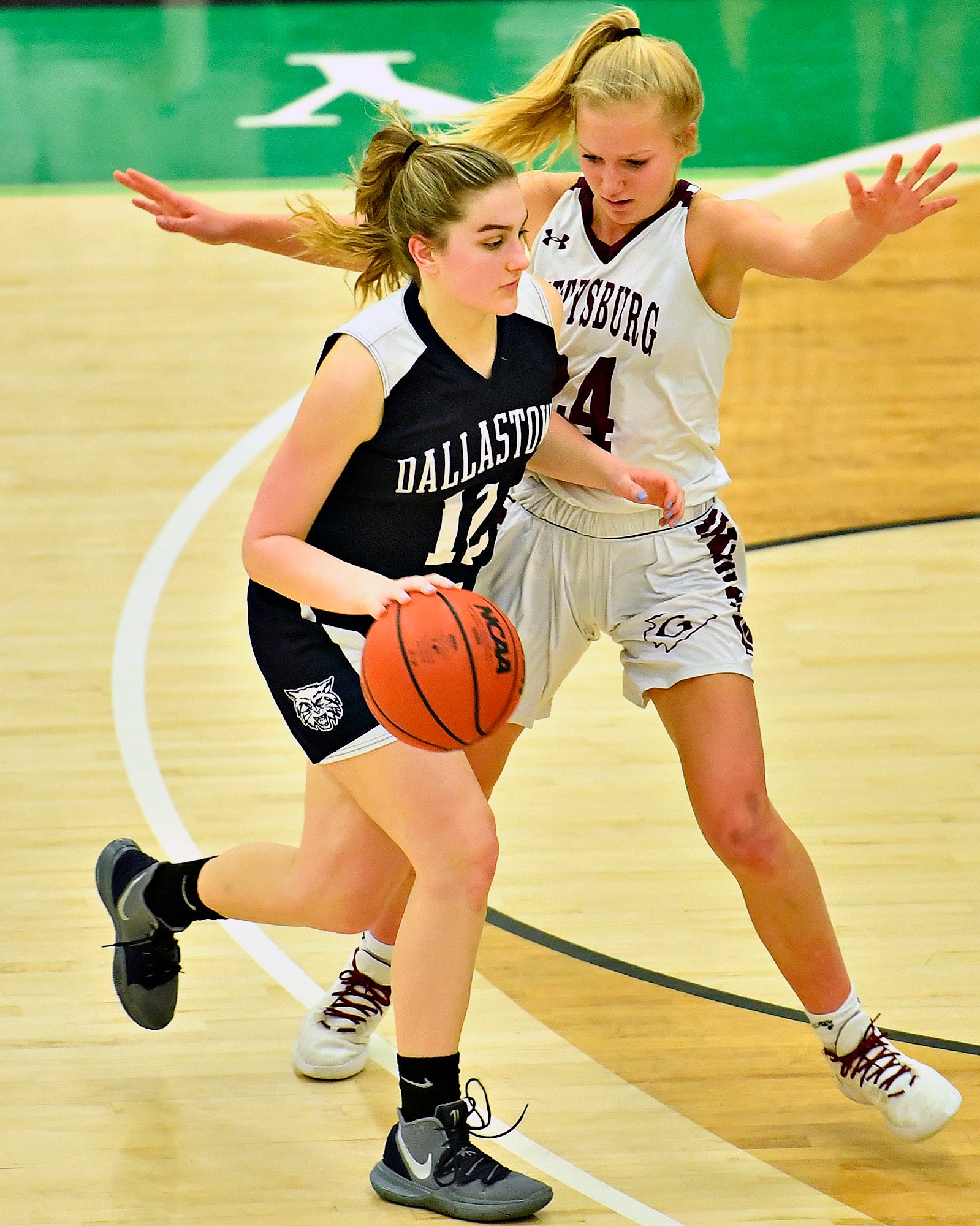 Dallastown's Ashley Harbold, left, works to get past Gettysburg's Anne Bair during YAIAA girls' basketball championship action at Grumbacher Sport and Fitness Center at York College of Pennsylvania in Spring Garden Township, Friday, Feb. 14, 2020. Dallastown would win the game 42-38. Dawn J. Sagert photo