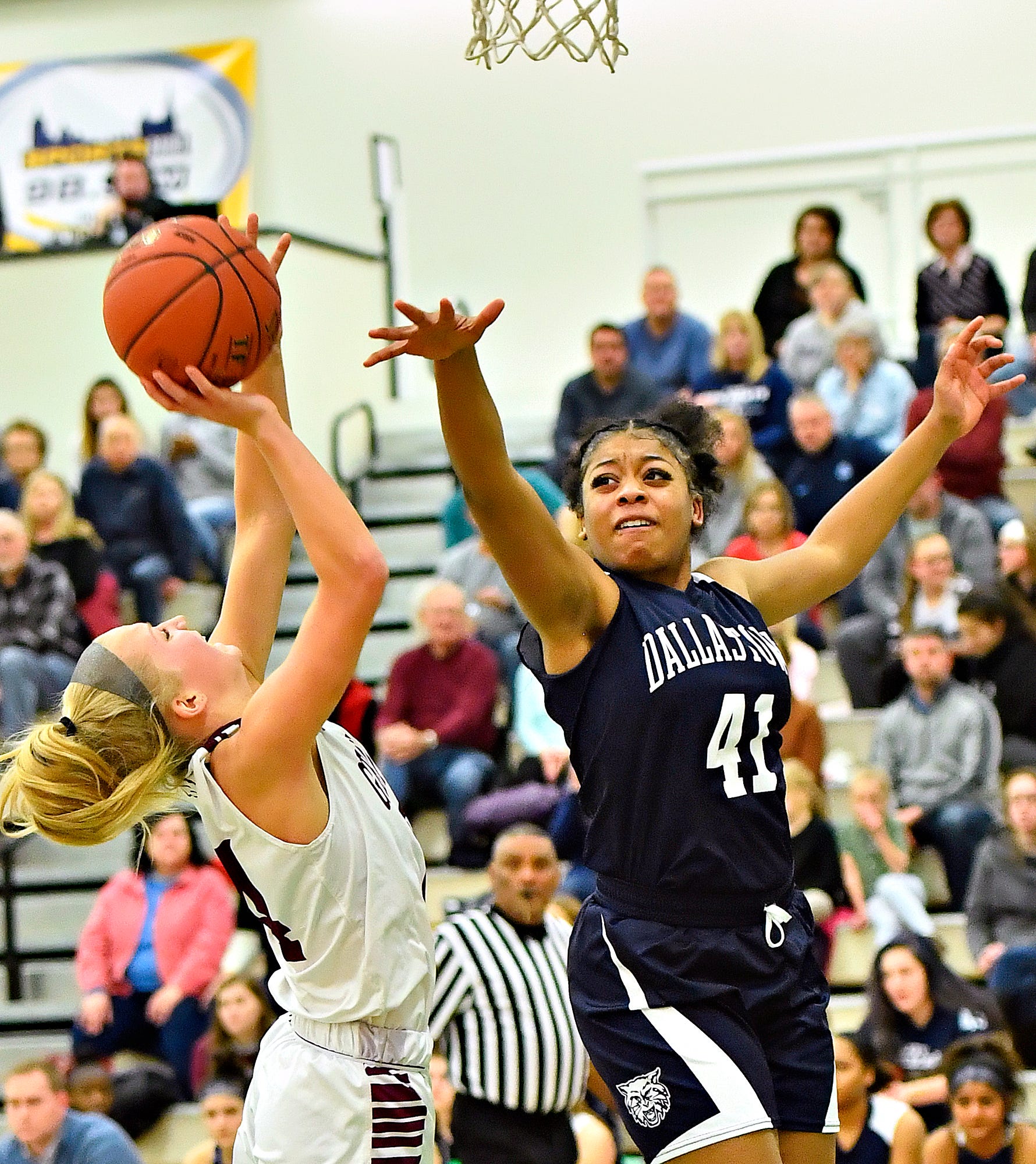 Gettysburg's Anne Bair, left, aims for the hoop while Dallastown's Bria Beverly defends during YAIAA girls' basketball championship action at Grumbacher Sport and Fitness Center at York College of Pennsylvania in Spring Garden Township, Friday, Feb. 14, 2020. Dawn J. Sagert photo