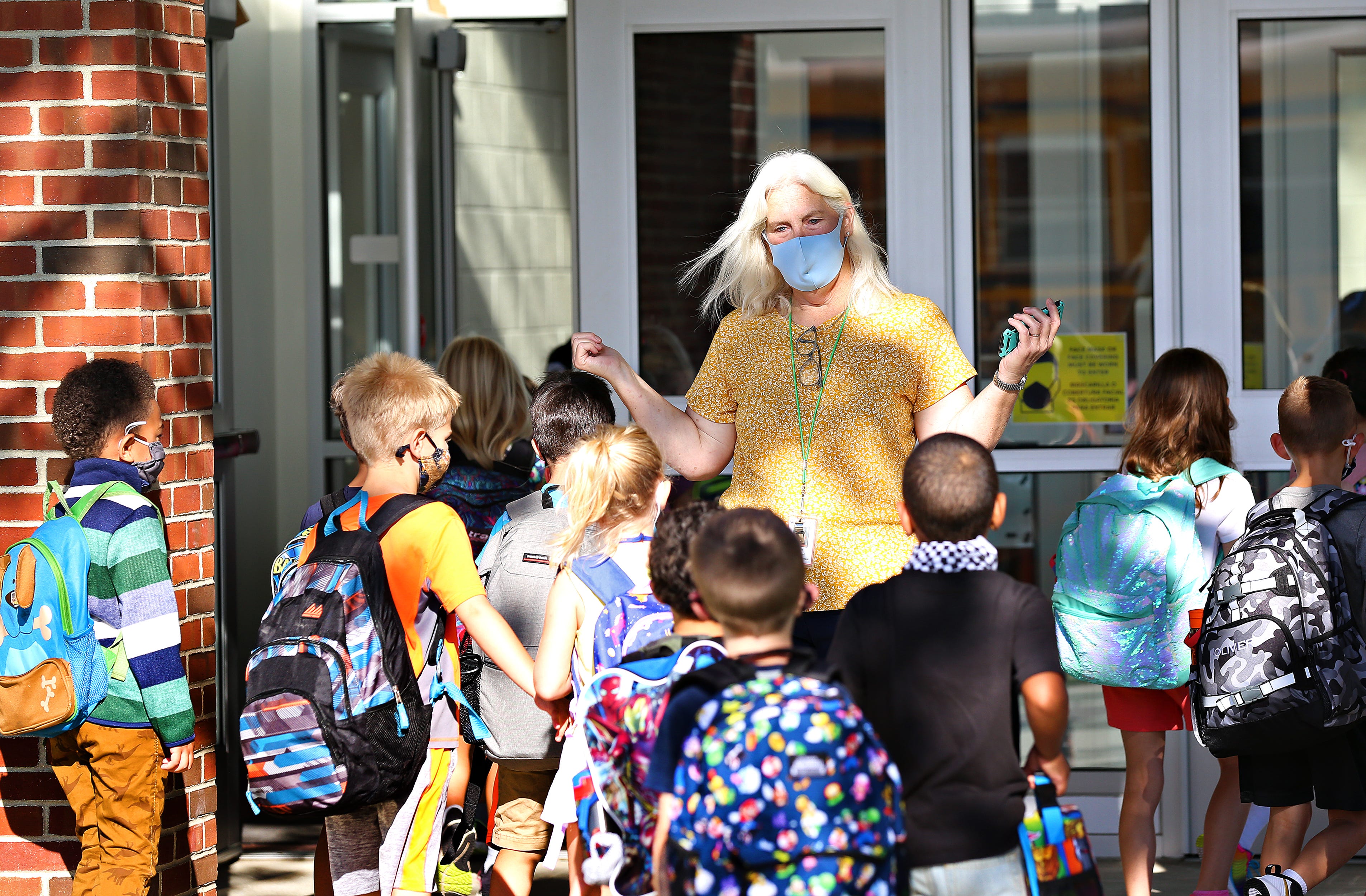 Para professional aide Jackie Dommel greets students as they arrive on the first day of school at Valley View Elementary School in Spring Garden Township, Thursday, Aug. 19, 2021. Dawn J. Sagert photo