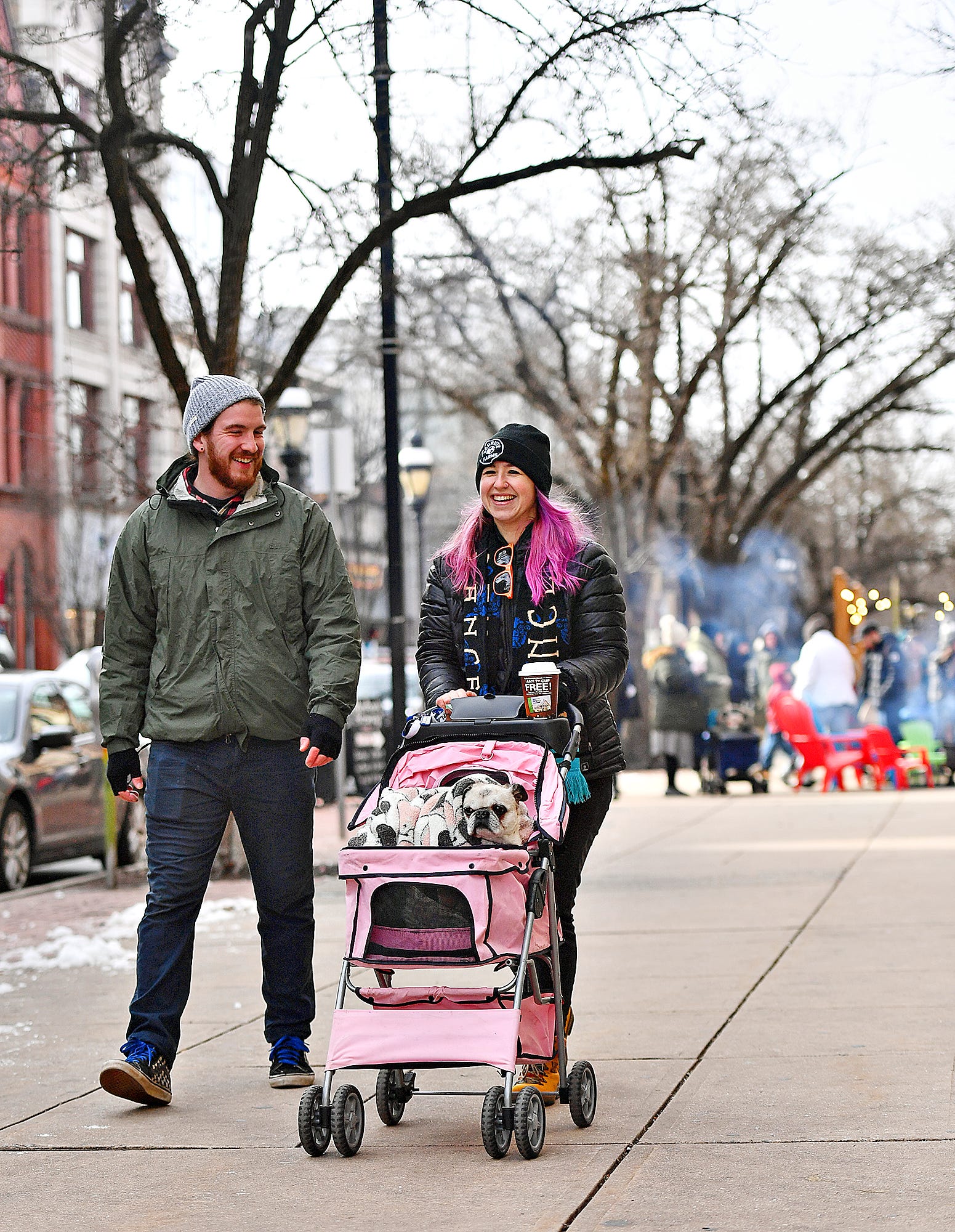 Mike Johnson, left, and Kaitlyn Ulrich, of Baltimore, walk along West Market Street with their 14-year-old pug Bella   during the 8th annual FestivICE event in downtown York City, Saturday, Jan. 15, 2022. Dawn J. Sagert photo