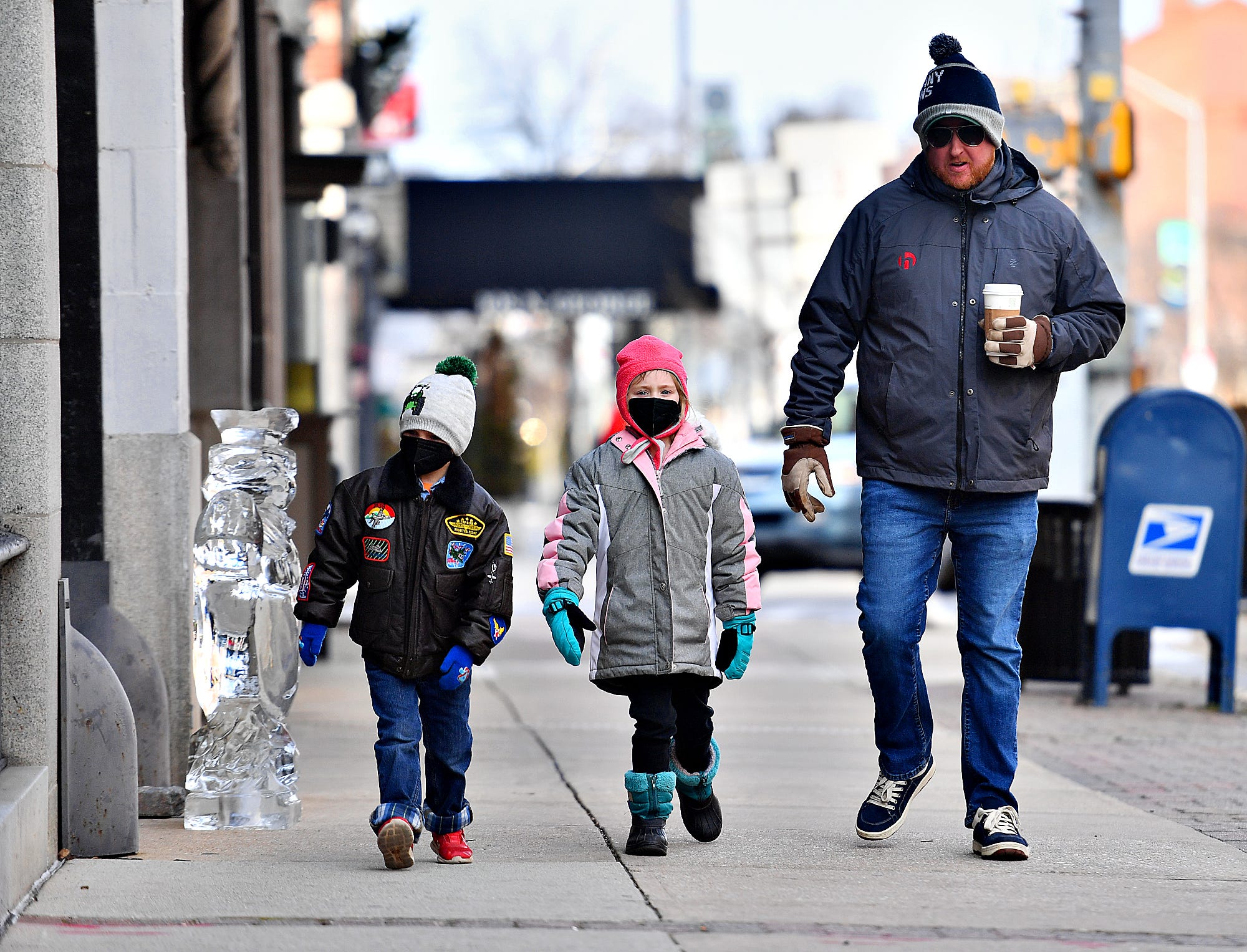 From right, Ryan Hayman, Sadie Hayman, 6, and Owen Hayman, all of Dover, walk along South George Street during the 8th annual FestivICE event in downtown York City, Saturday, Jan. 15, 2022. Dawn J. Sagert photo