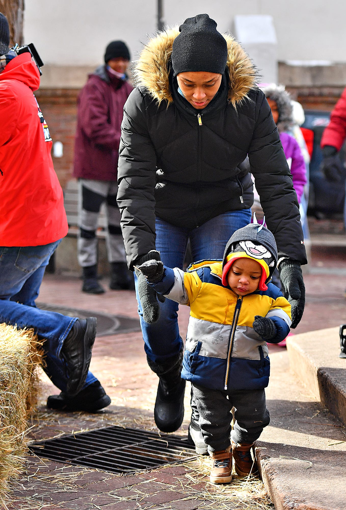 Jazzmine Magloire, of Spring Garden Township, follows her son Jonathan Magloire, 1, closely during the 8th annual FestivICE event in downtown York City, Saturday, Jan. 15, 2022. Dawn J. Sagert photo