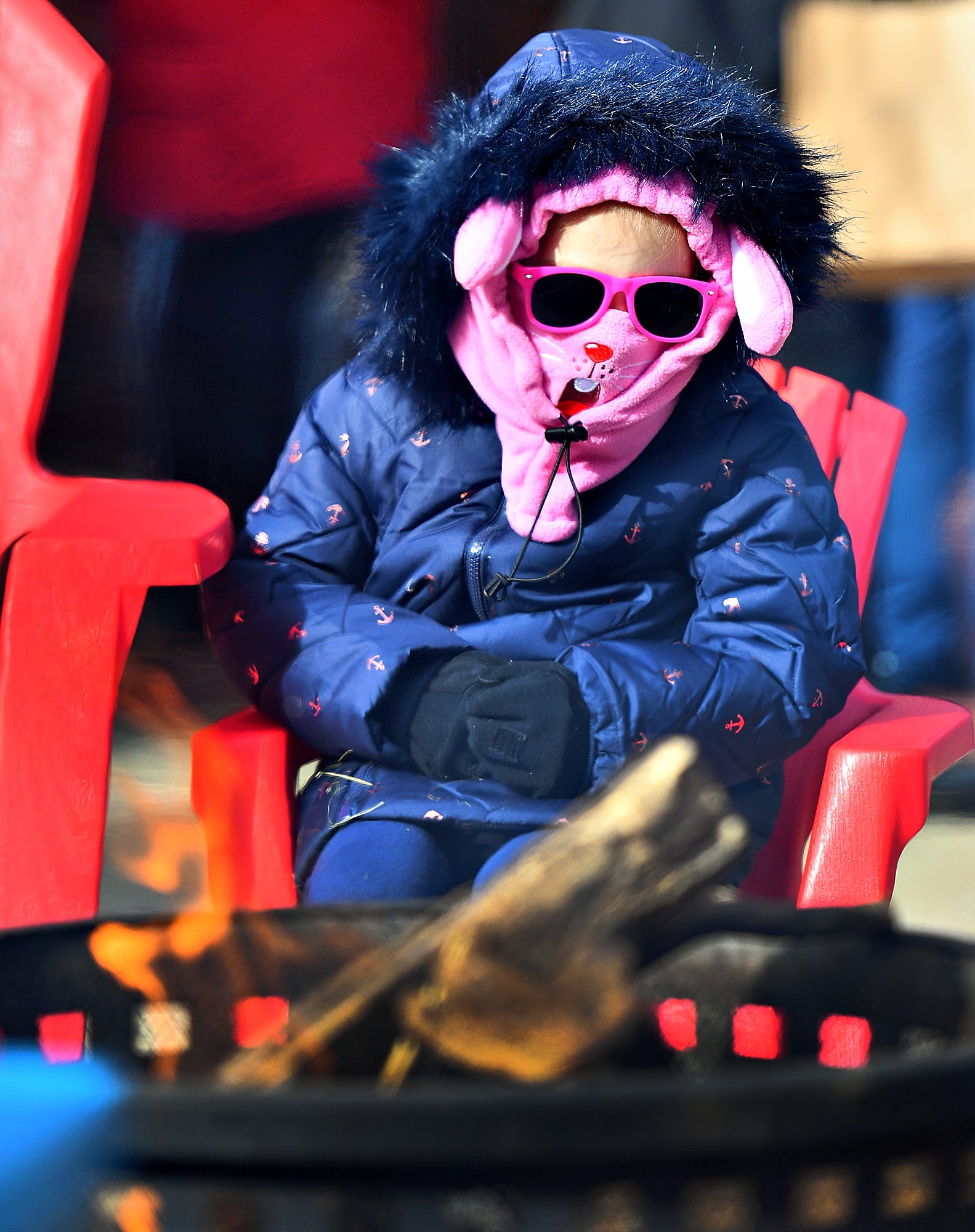 Bethany Mulliken, 5, of Lewisberry, warms herself by the fire pit during the 8th annual FestivICE event in downtown York City, Saturday, Jan. 15, 2022. Dawn J. Sagert photo
