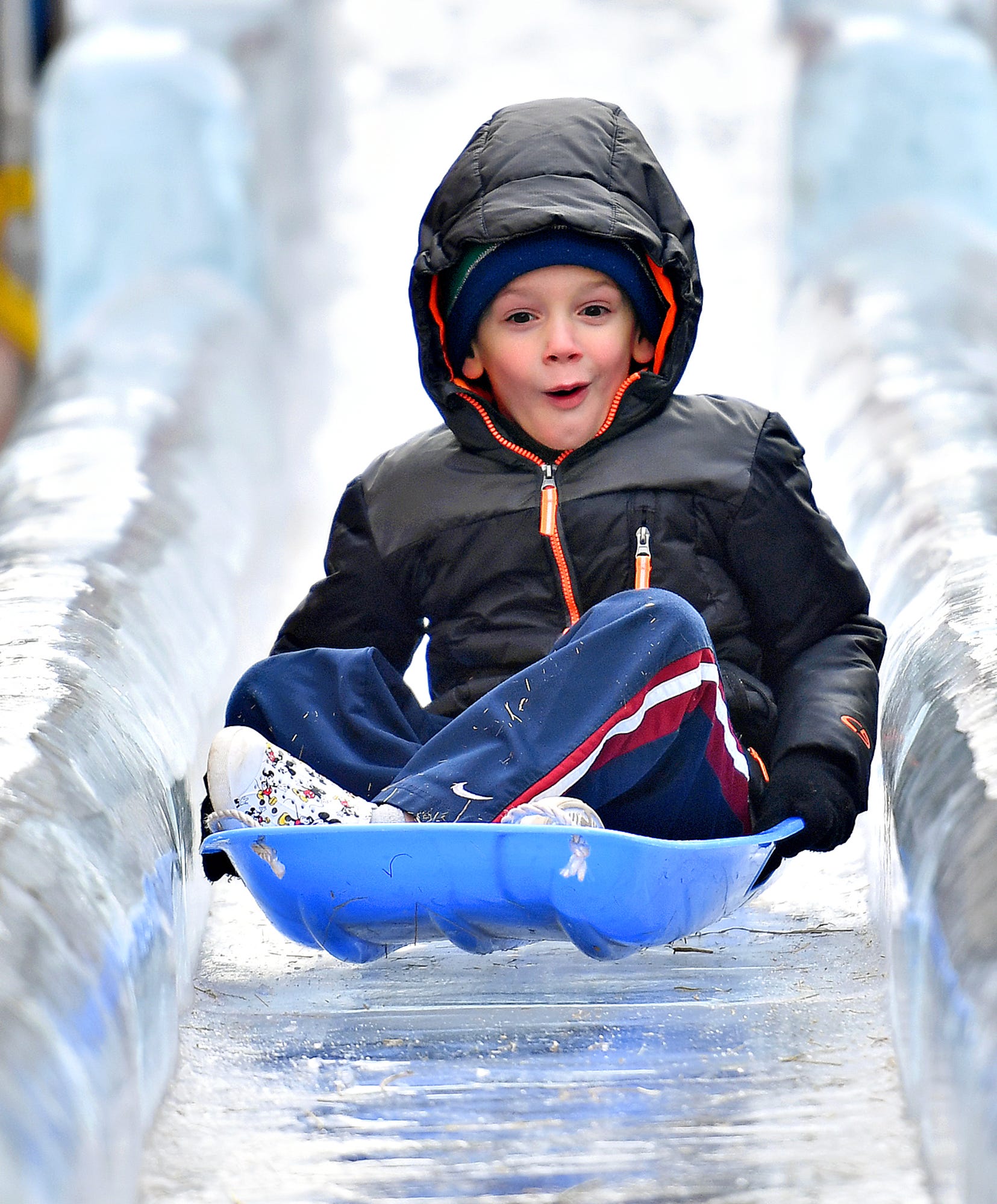 Mason Grunden, 5, of Manchester Township, slides down the 40-foot WellSpan Ice Slide during the 8th annual FestivICE event in downtown York City, Saturday, Jan. 15, 2022. Dawn J. Sagert photo