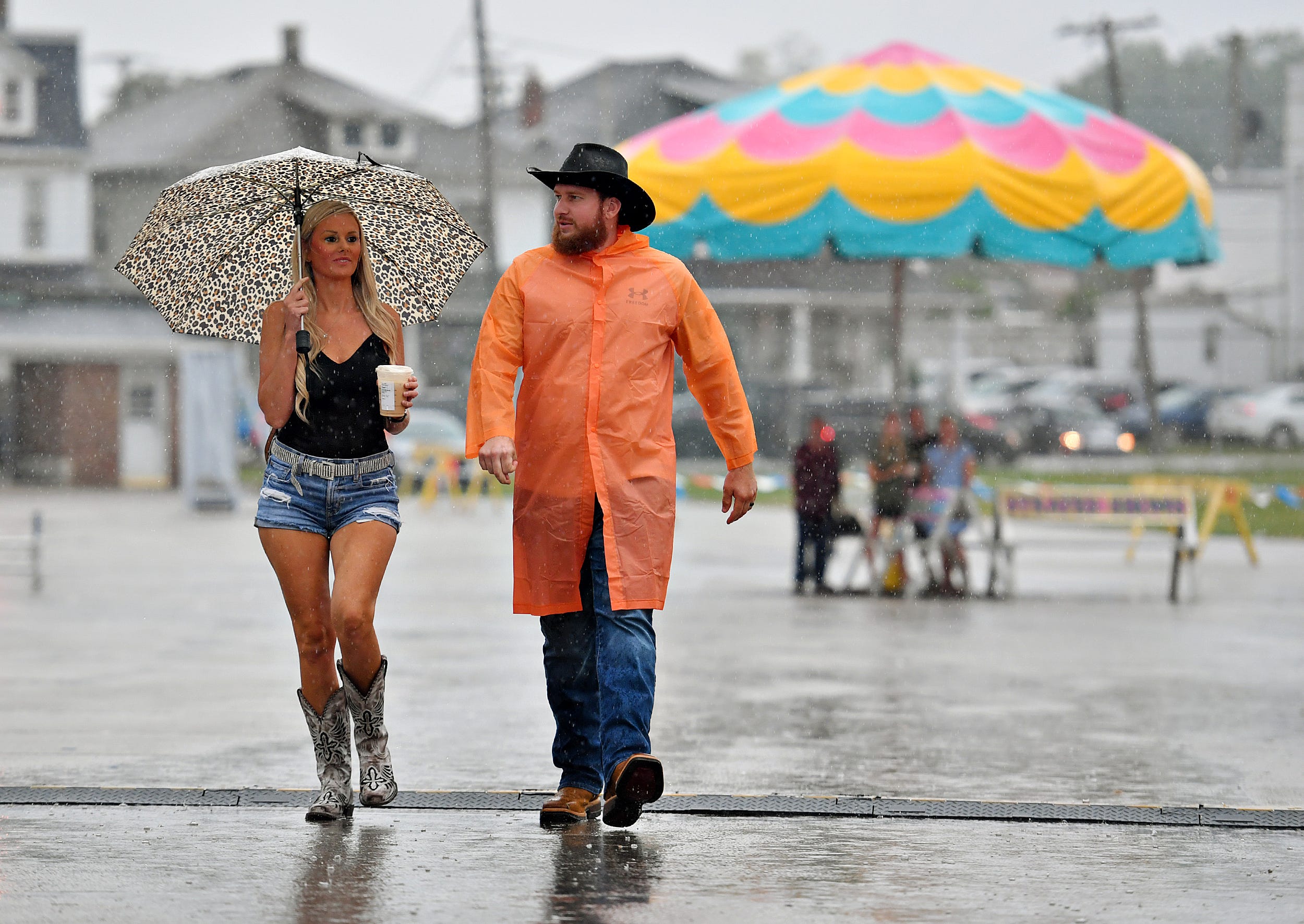 Sarah and Mike Brubaker, from McAlisterville in Juniata County, brave the rain to see Jason Aldean perform during the final day of York State Fair in York, Pa., Sunday, July 31, 2022. Dawn J. Sagert/The York Dispatch