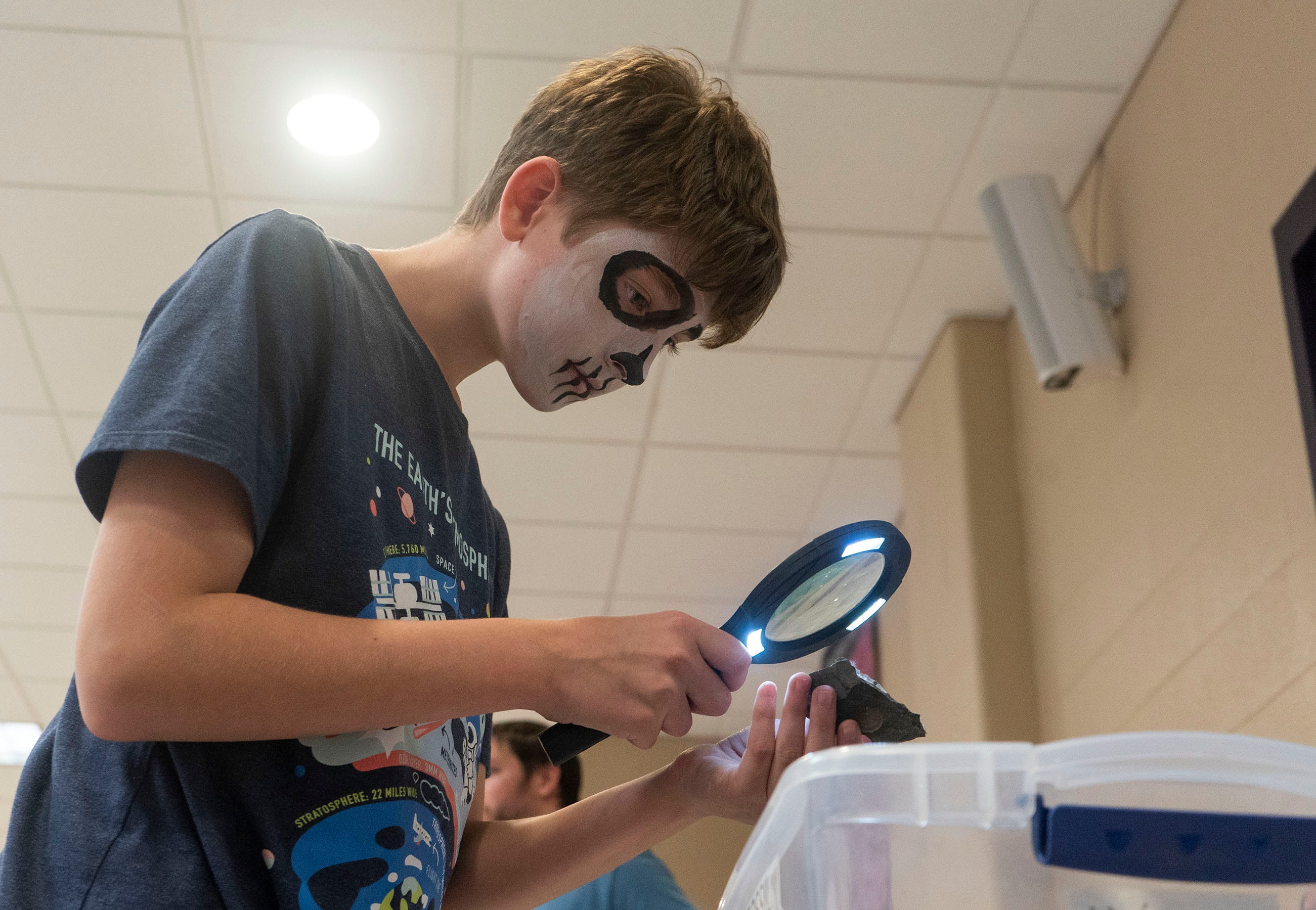 Travis Reese (10), from Hellertown, PA, looking at geodes at the Satanic Temple's back to school event at Northern High School in Dillsburg on Saturday, Sept. 24, 2022.